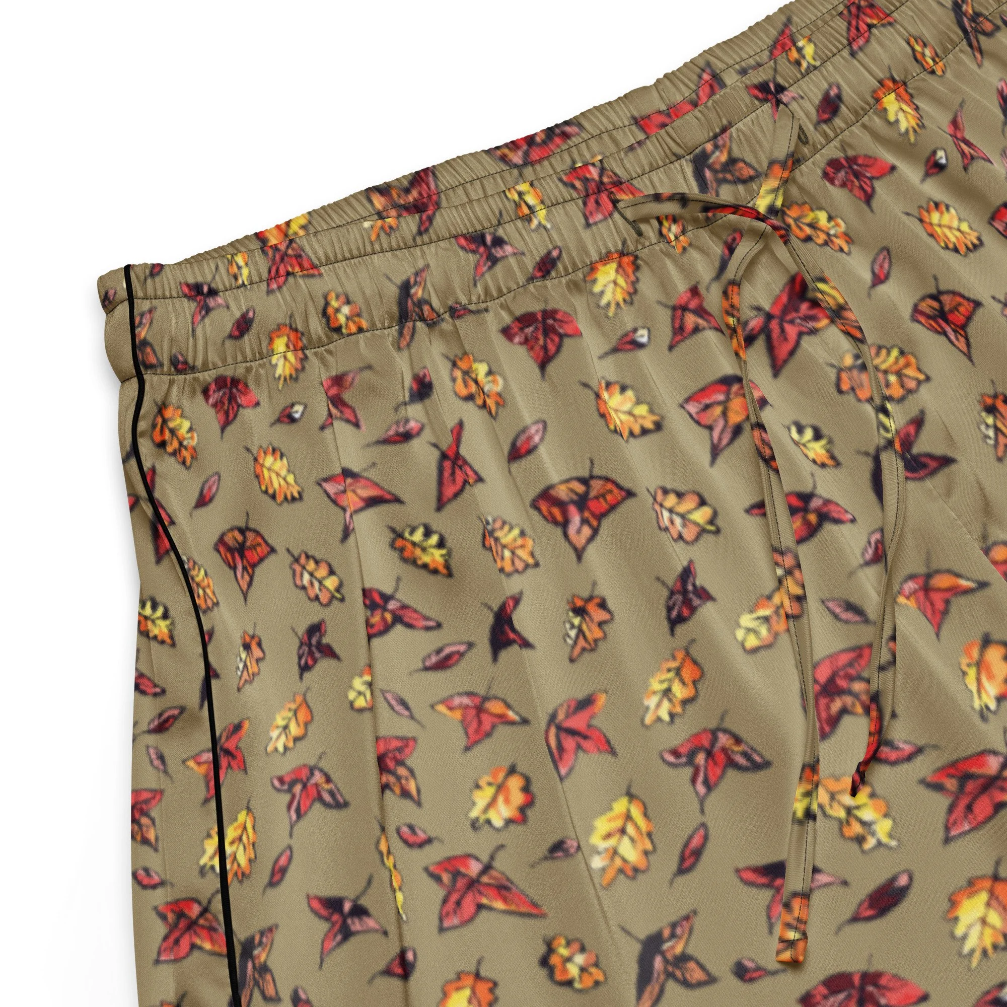 Close-up of the Green Falls pyjama shorts' autumn leaf print and black side piping on olive fabric