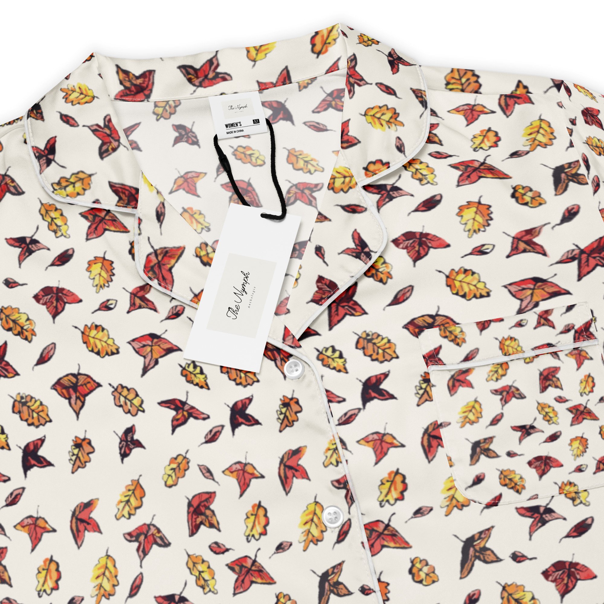 Close-up of the Autumn Chills pyjama top's autumn leaf print in red, orange and yellow on white fabric