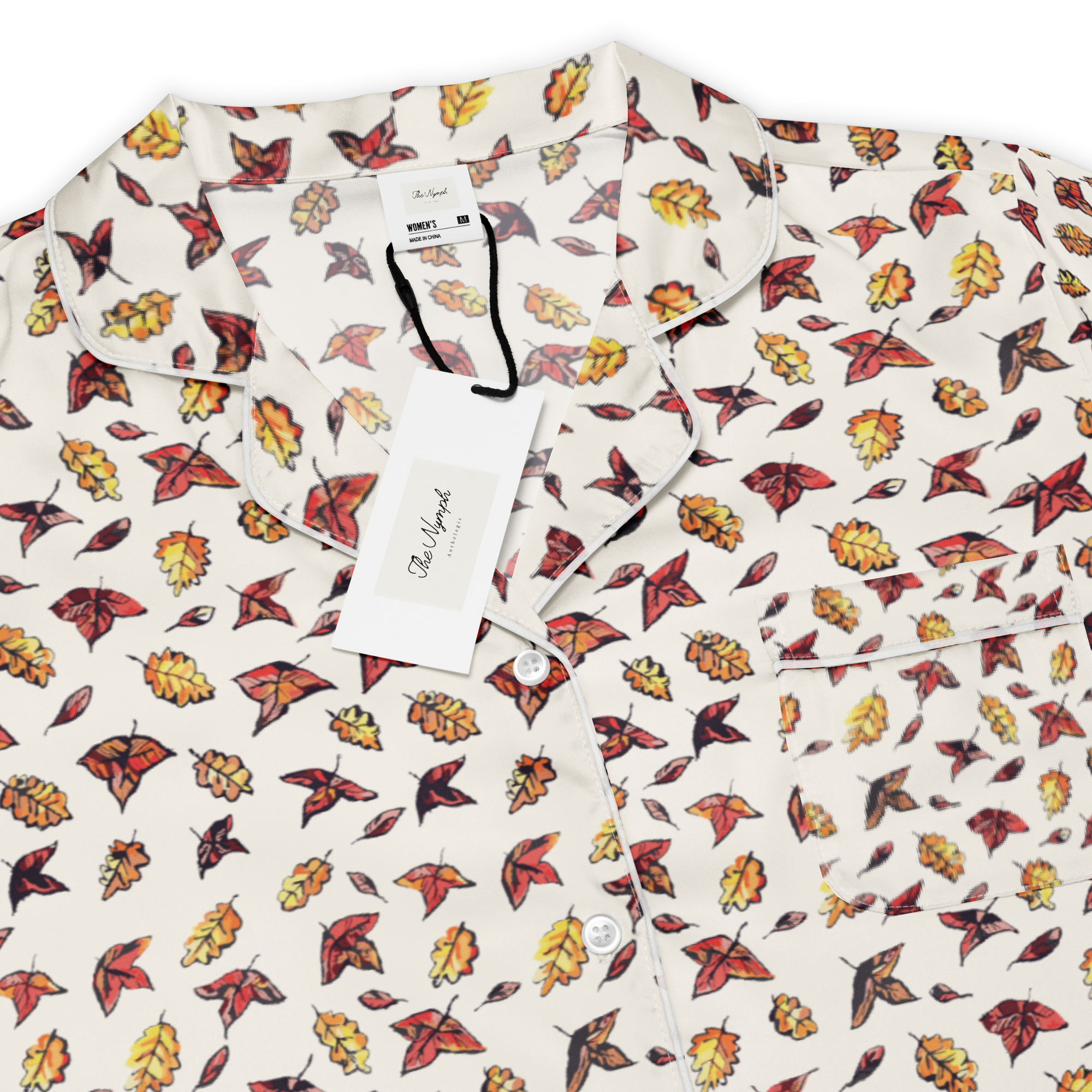 Close-up of the Autumn Frost pyjama top's red, orange and yellow autumn leaf print on cream fabric