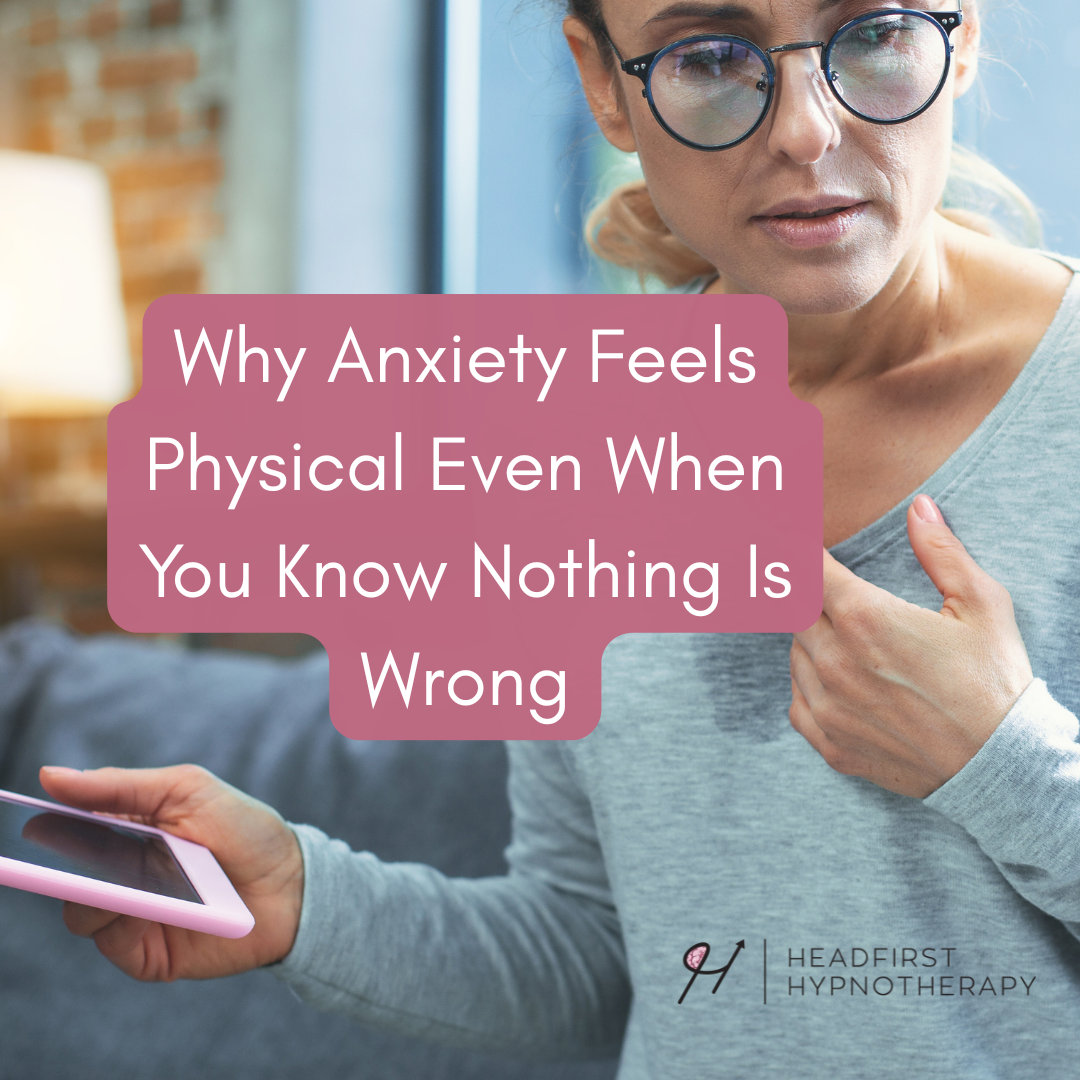 Person experiencing physical symptoms of anxiety, touching their chest while holding a phone, showing how anxiety can feel physical even when nothing is wrong