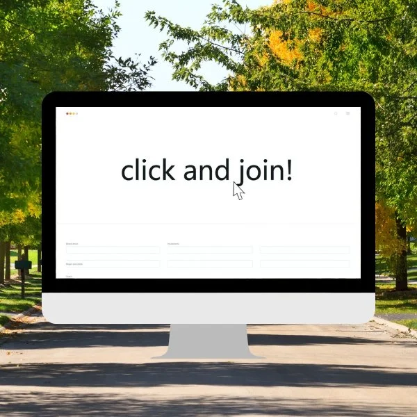 Computer screen displaying the text "click and join!" with a mouse cursor, outdoors in a park with trees and a paved pathway.