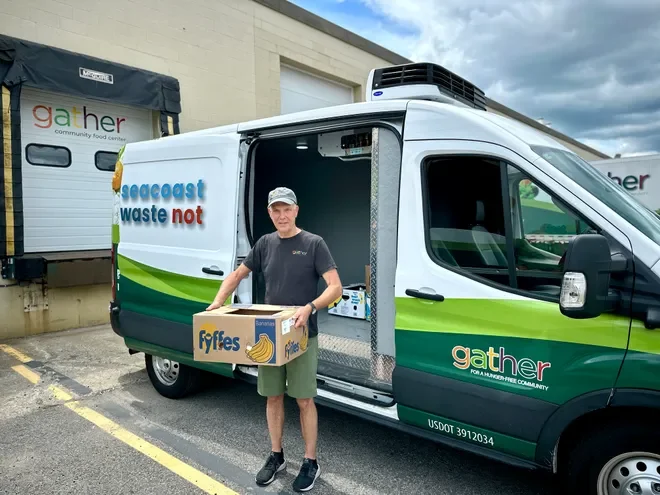 Gather's Korty Church unloads a banana box from the Seacoast Waste Not Van at Gather's Portsmouth Warehouse