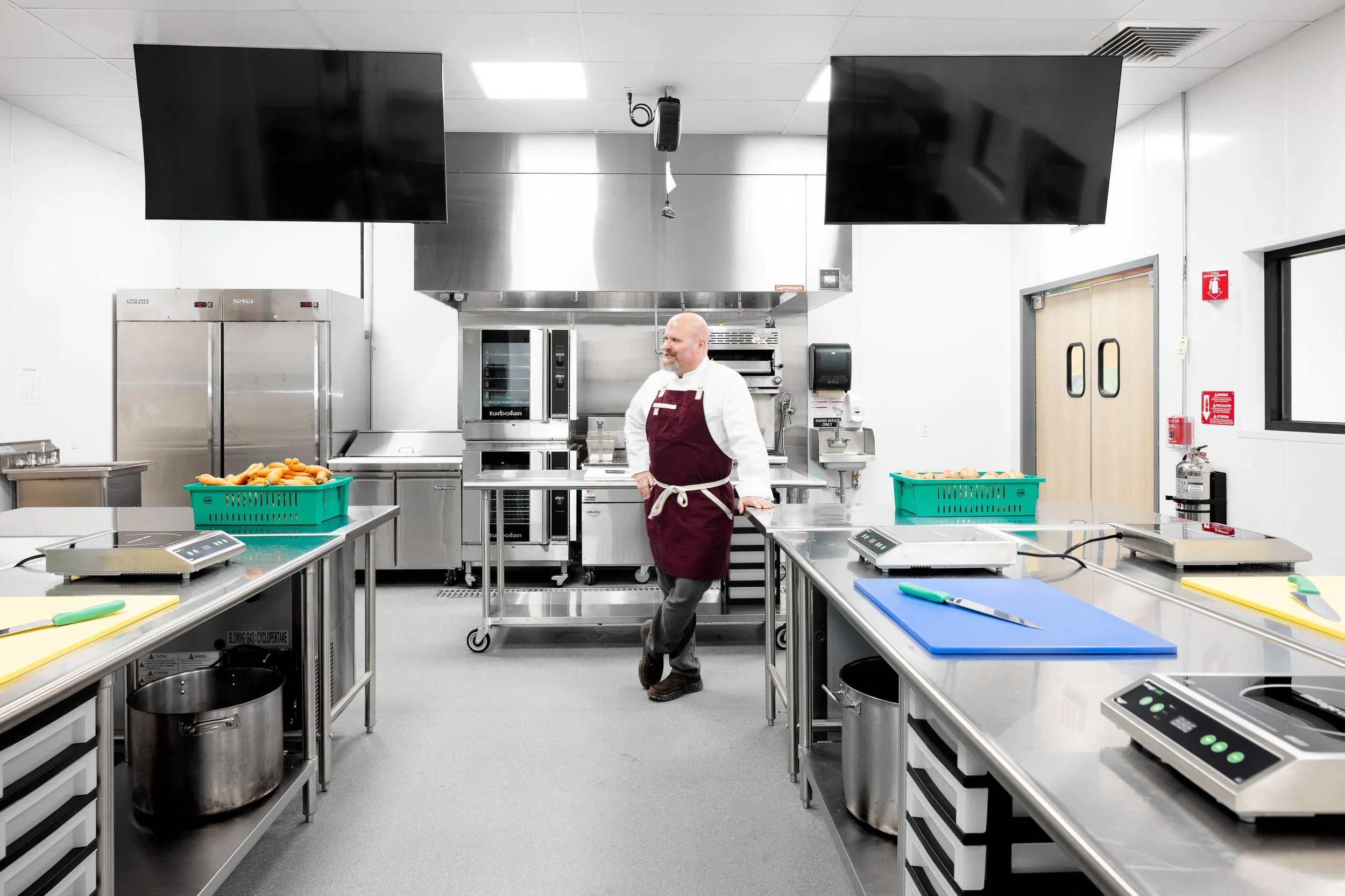 Gather Chef Instructor Tim Barr standings in Gather's new Culinary Training Kitchen