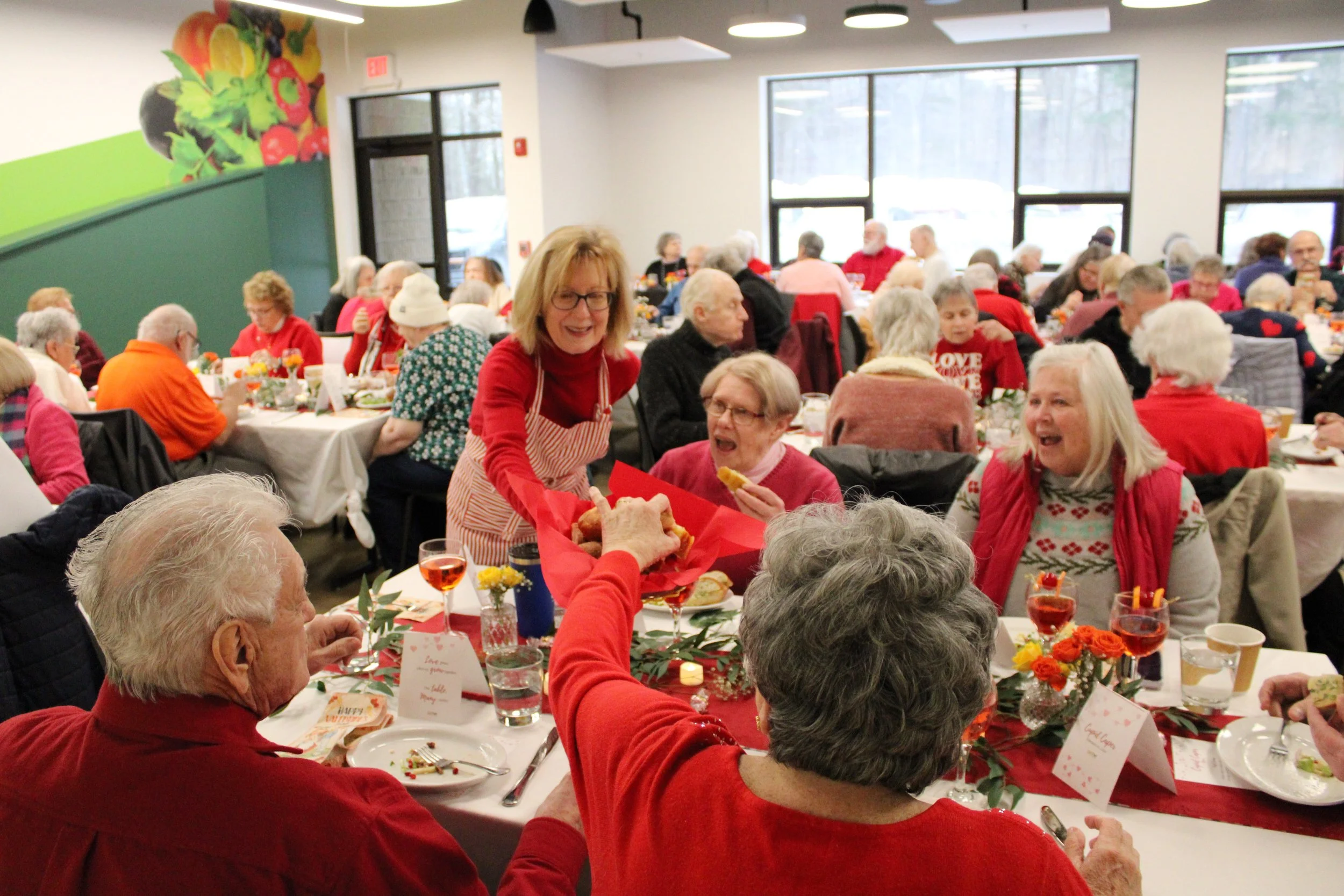 Gather volunteer services a group of seniors at Valentine's dinner