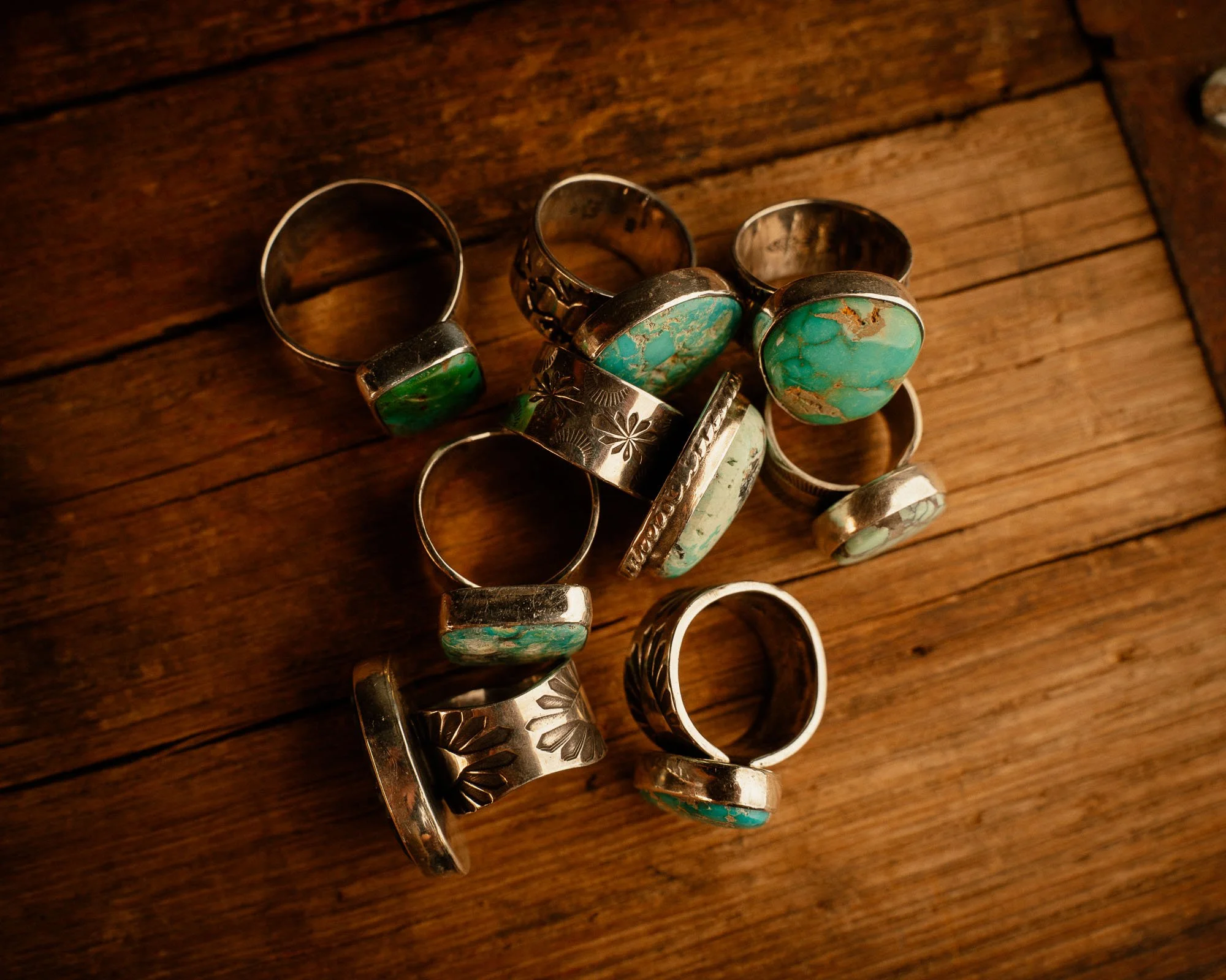 Custom Turquoise Rings in a pile.