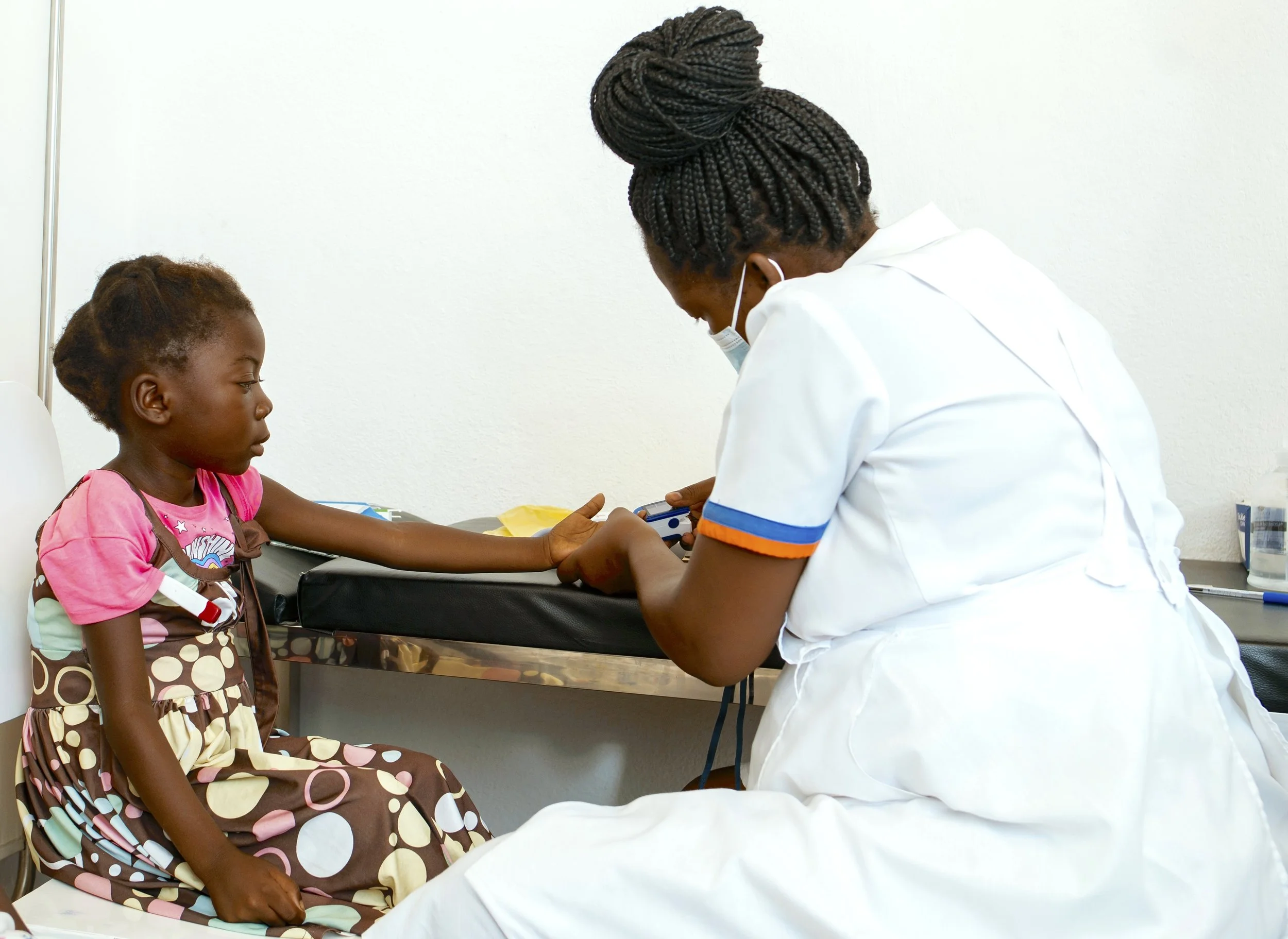 Linda, a young girl with sickle cell disease, with nurse in clinic