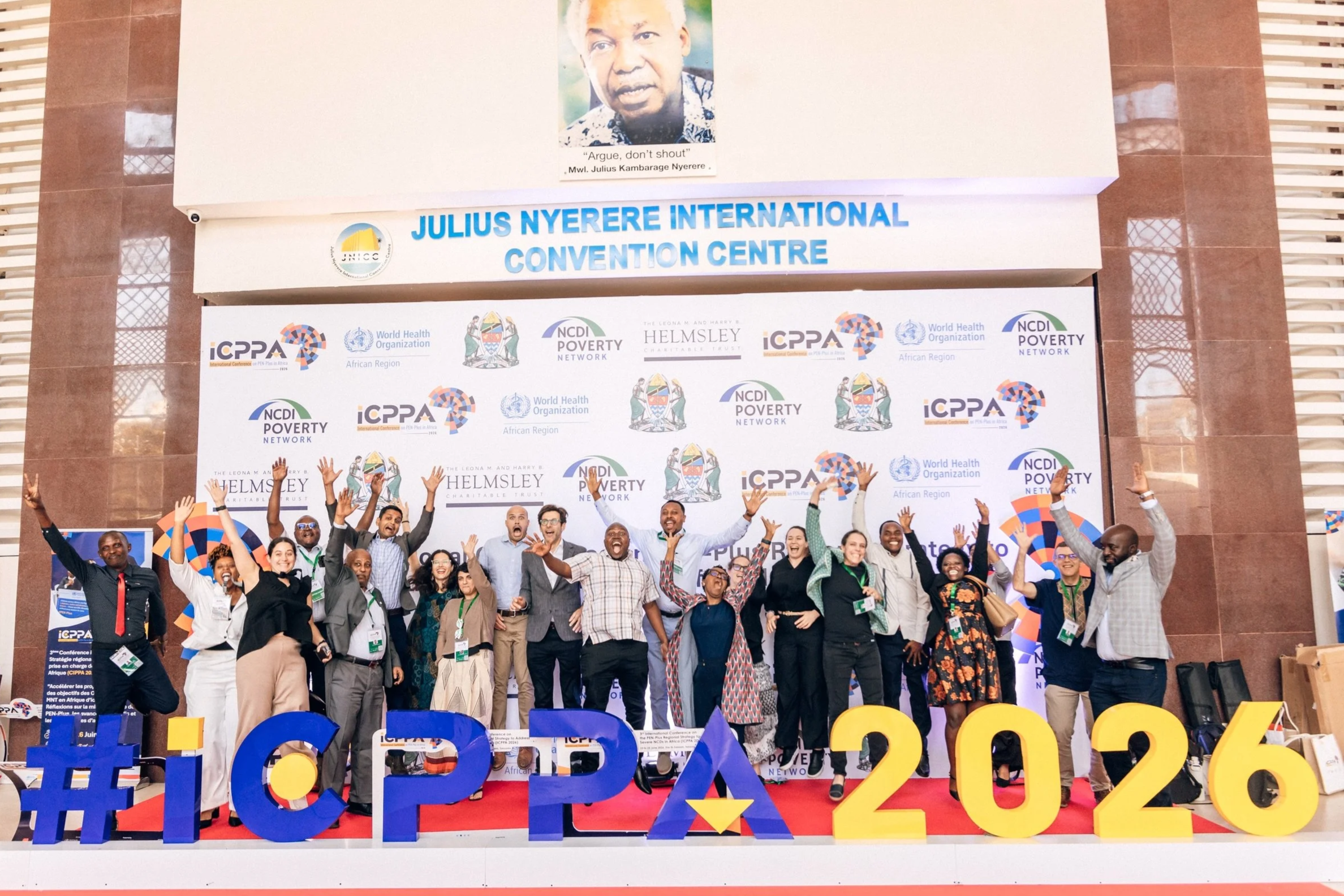  Members of the NCDI Poverty Network take a celebratory jump at the end of the Third International Conference on PEN-Plus in Africa. 