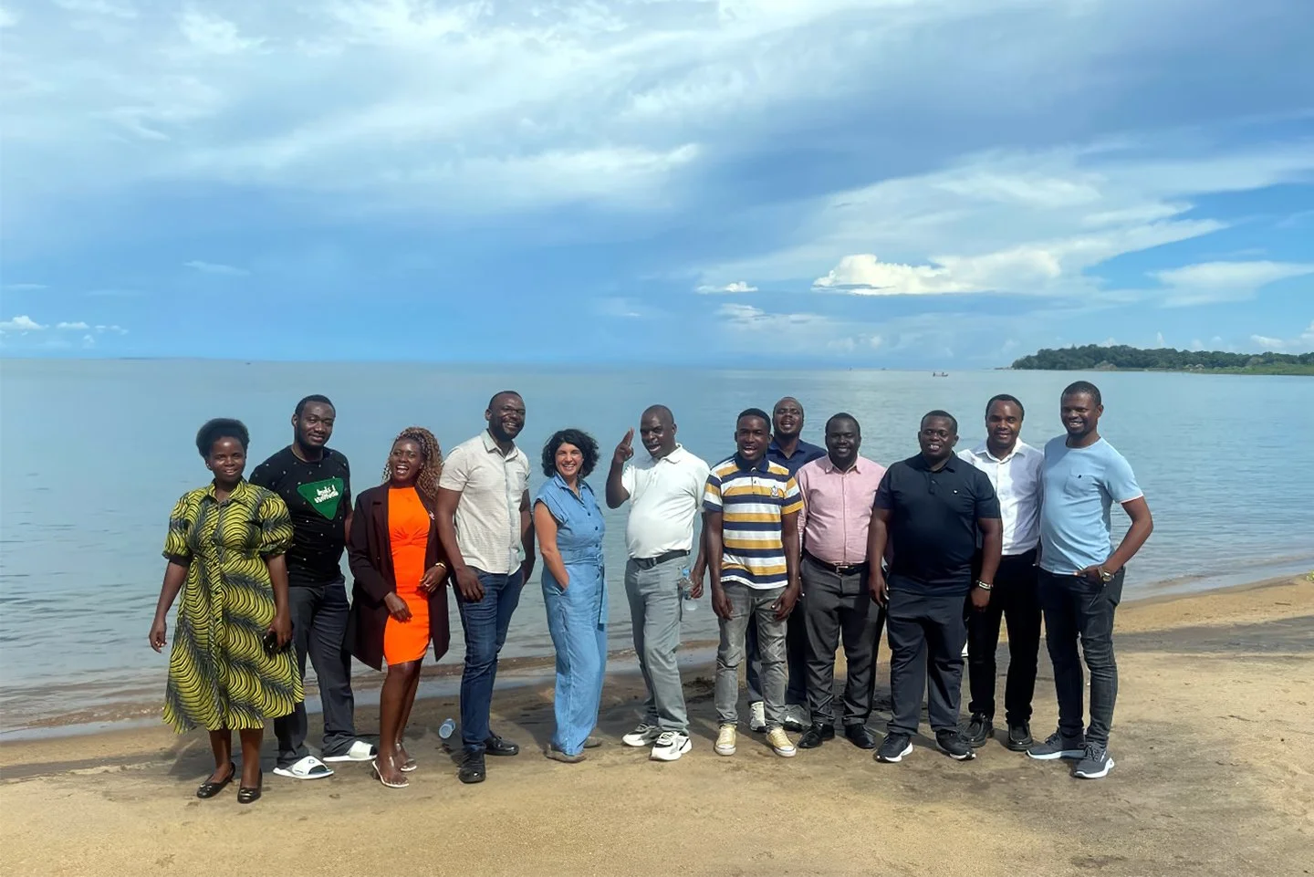 PEN-Plus trainers and trainees stand on the shores of Lake Malawi
