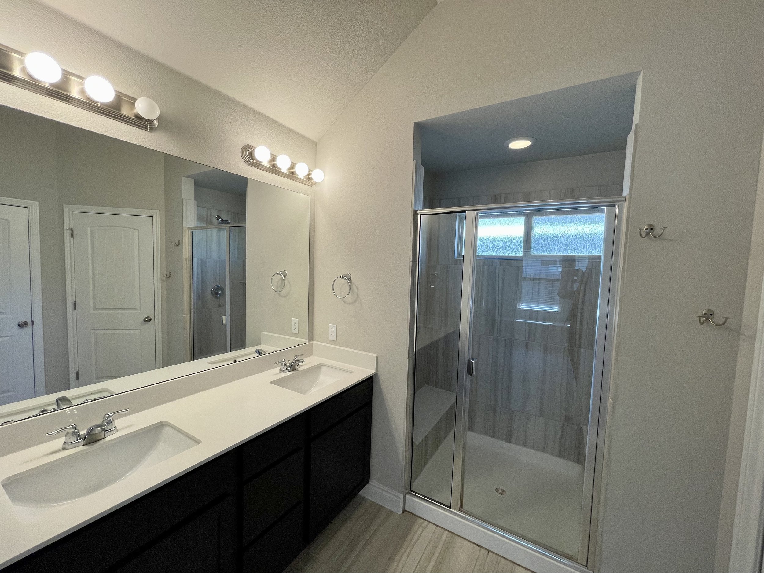 Primary bathroom offers double vanities.