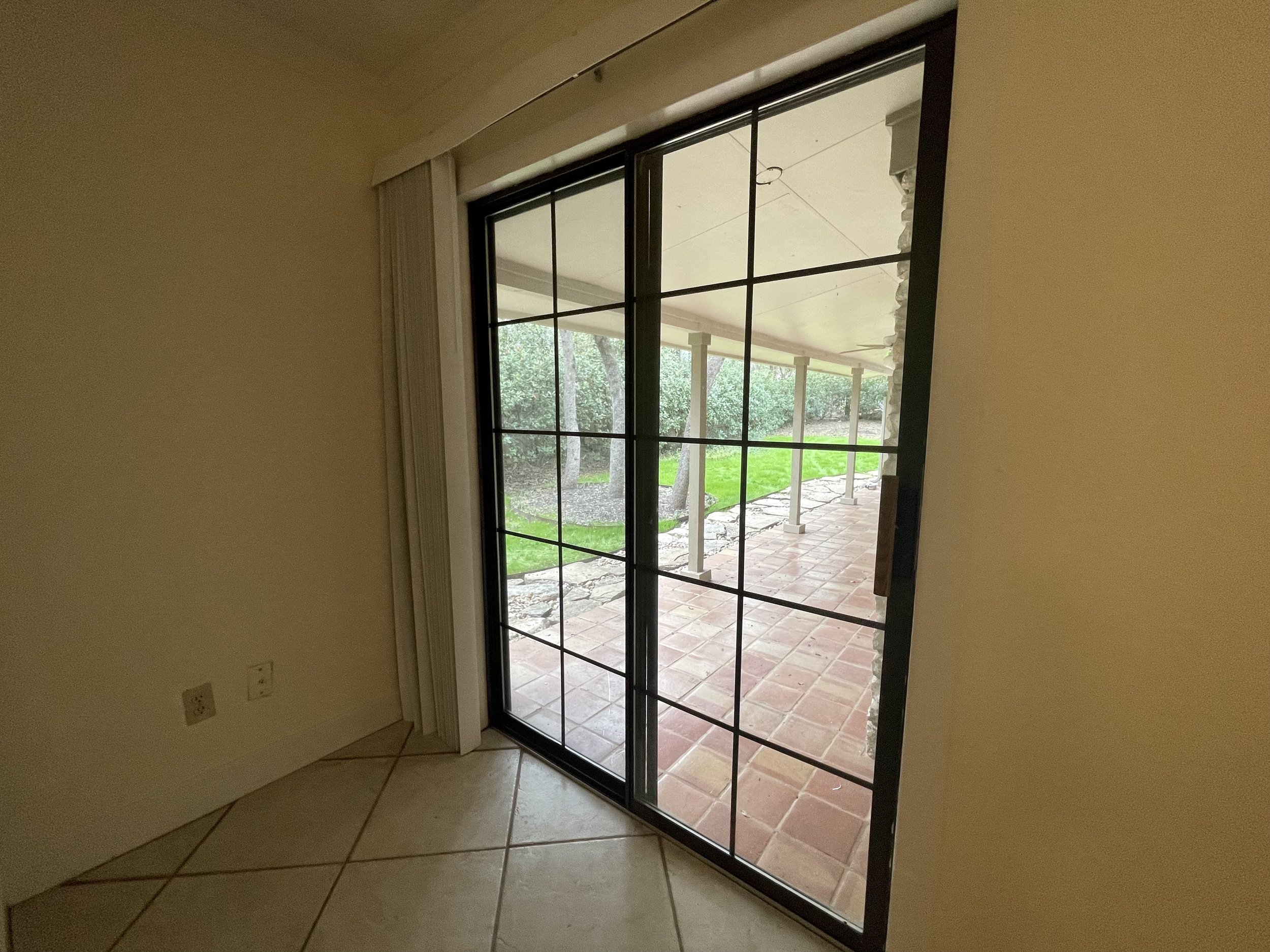 Primary bedroom features a sliding glass door to backyard.