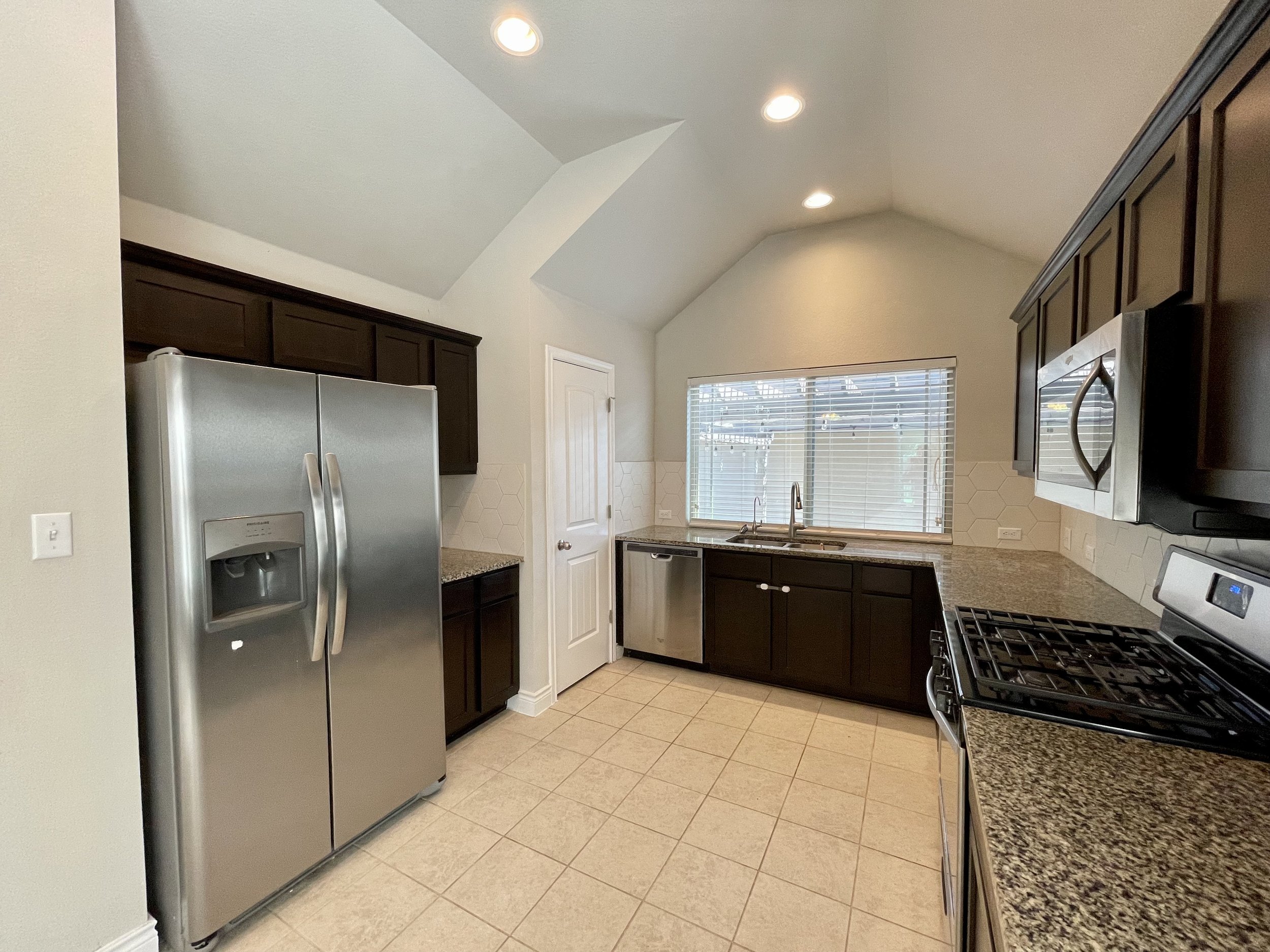 Kitchen. Refrigerator is there for tenant use but not maintained by landlord.