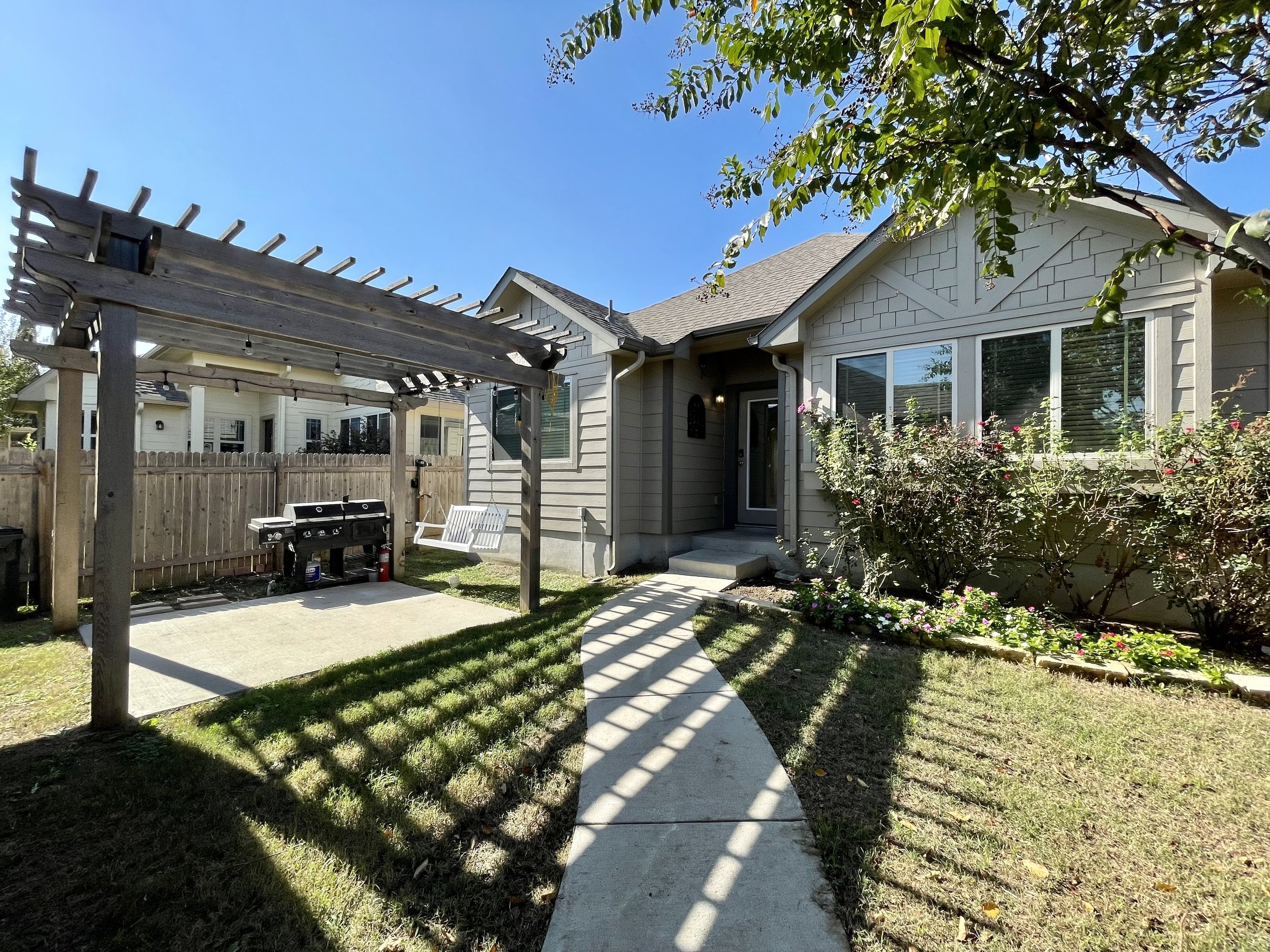 This courtyard style home features a pergola!!
Swing and grill not staying.