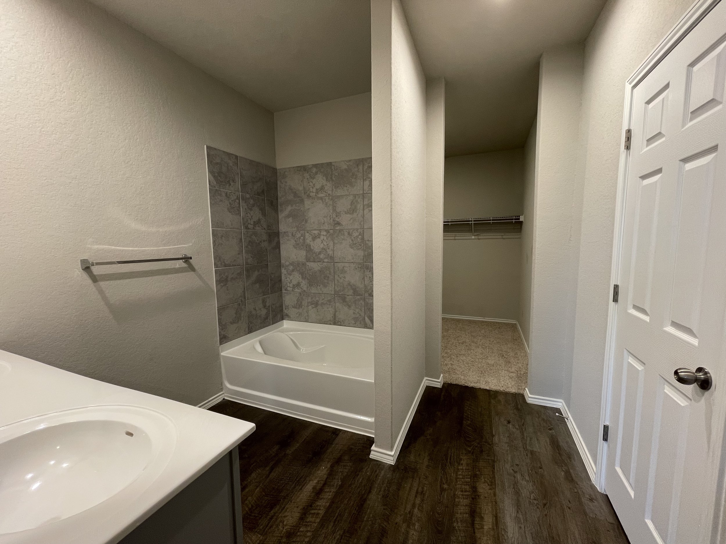 Primary bathroom leading to large walk in closet