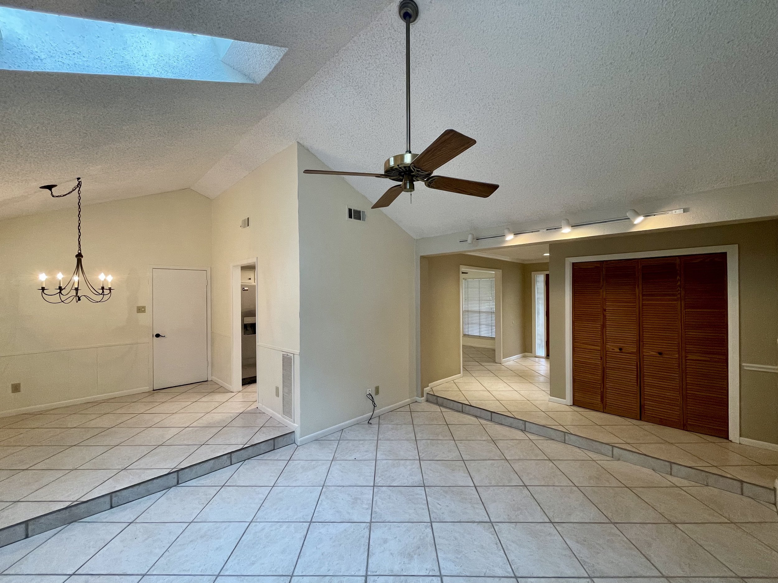 Living room has a tall vaulted ceiling with skylights for great natural light.