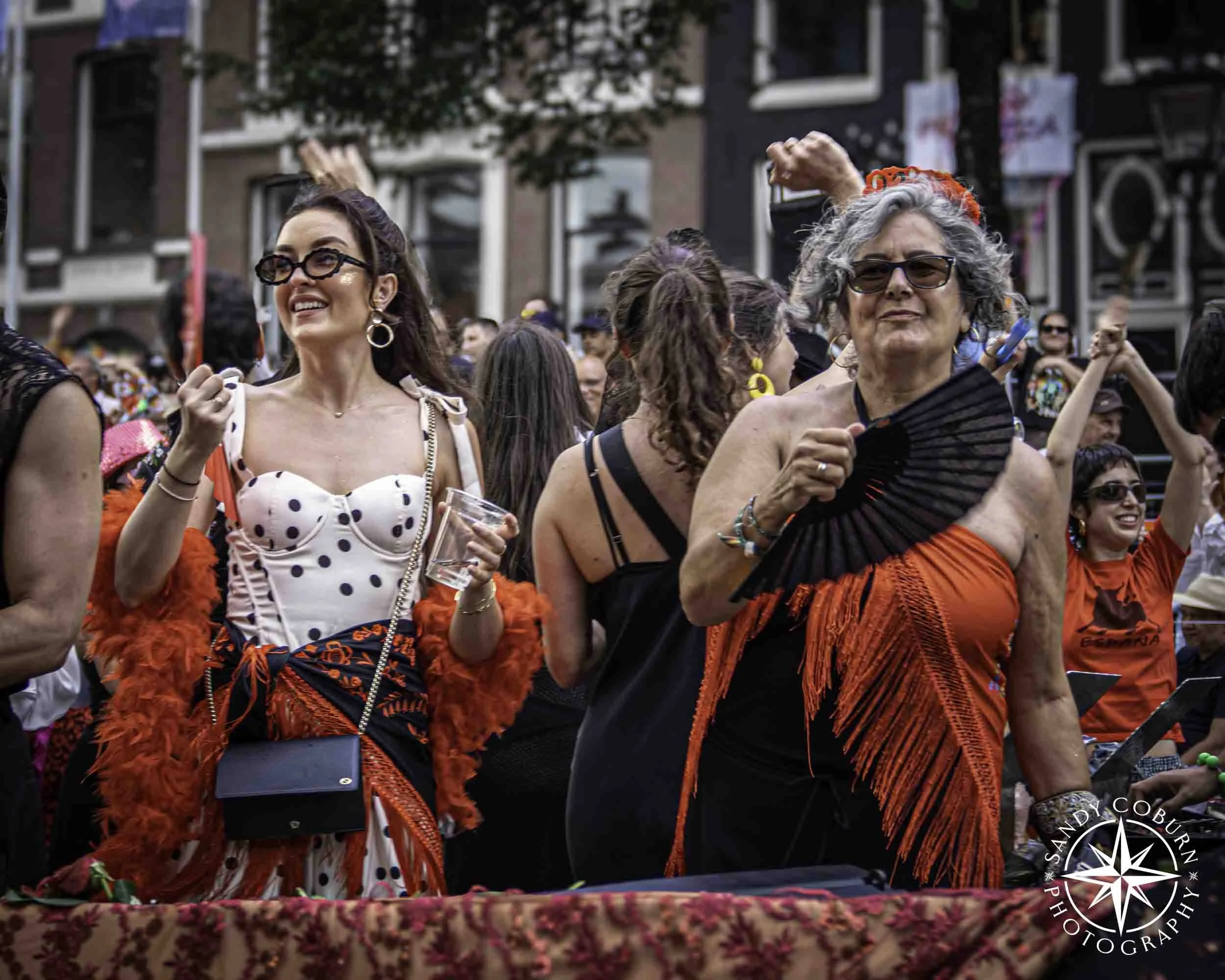 Two participants on the Barcelona Pride boat at the 2026 WorldPride Amsterdam Canal Parade