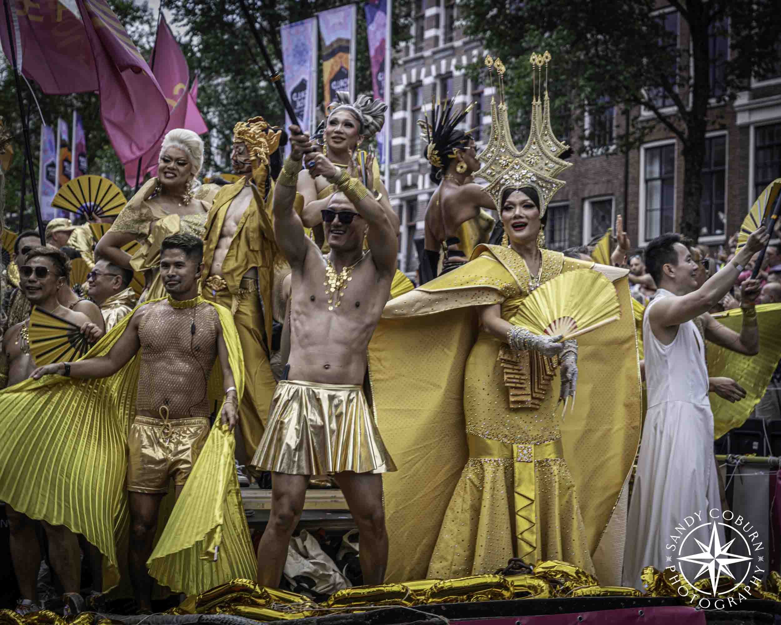 Asian Pride boat participant in gold at the 2026 WorldPride Amsterdam Canal Parade