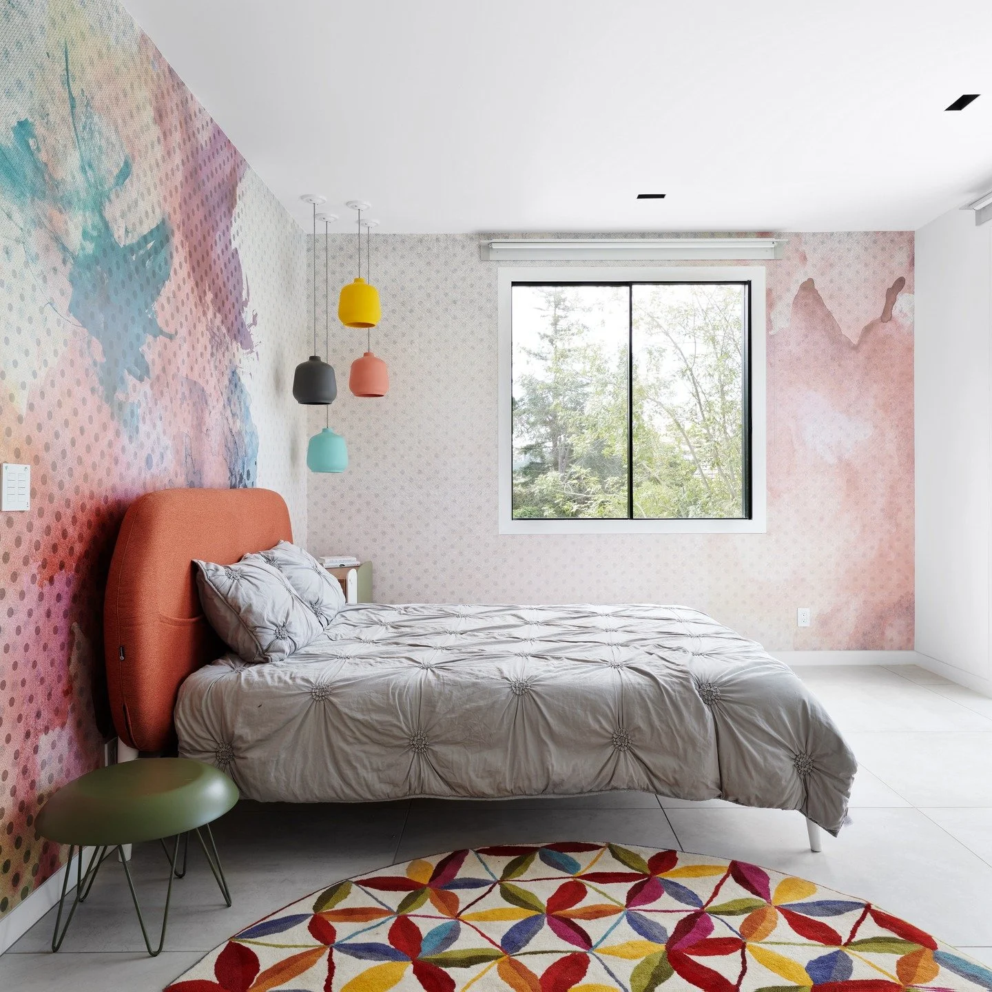 There&rsquo;s something really special about a room where light, color, and personality all meet effortlessly.

In this bedroom, the mural wallpaper sets the tone, soft washes of color layered with subtle texture, almost like a piece of art wrapping 