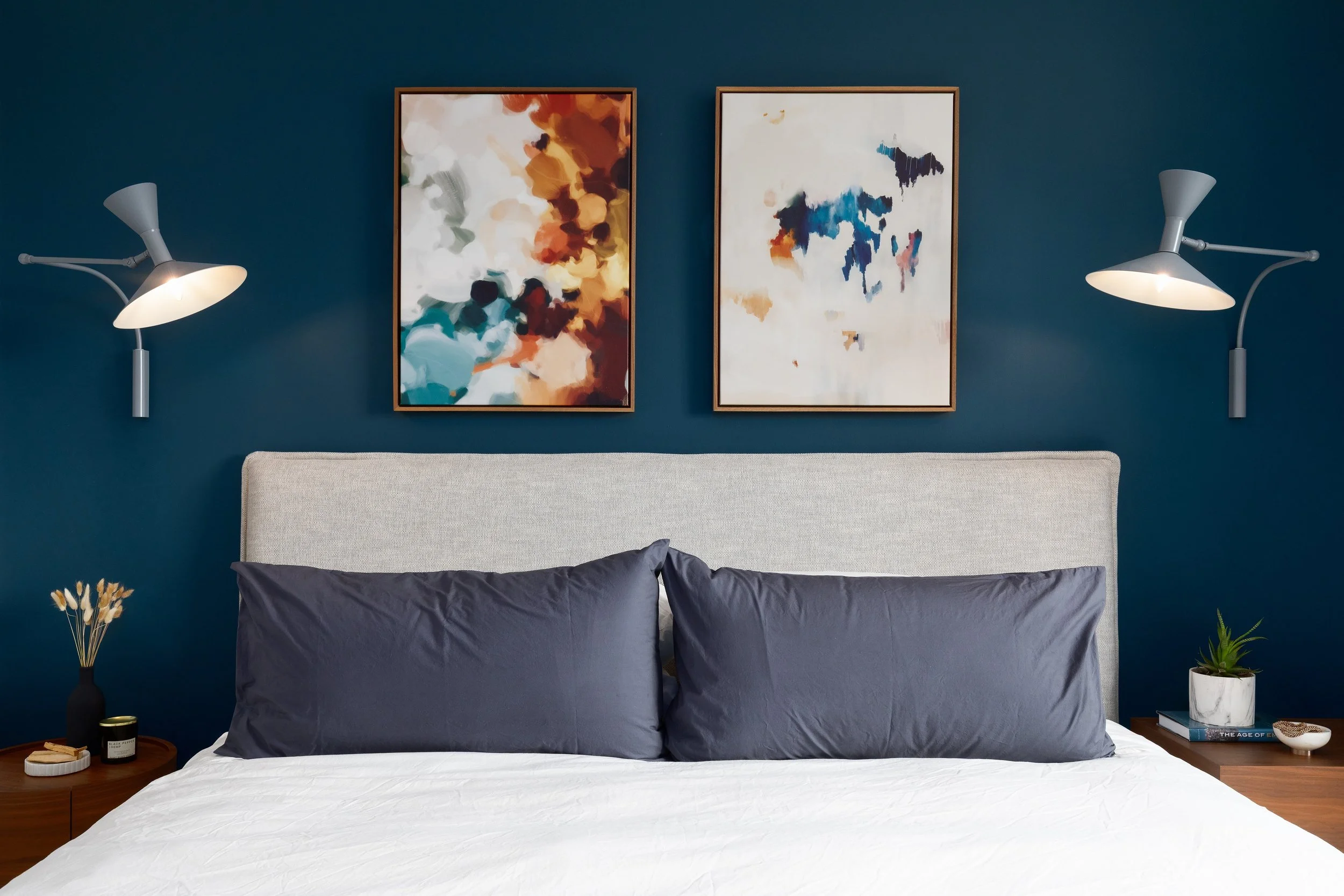 A bold wall color, warm walnut tones, layered lighting, and artwork that brings movement into the space.

This San Francisco bedroom was designed to feel calm, intimate, and quietly dramatic at the same time. I love how the deep blue backdrop transfo