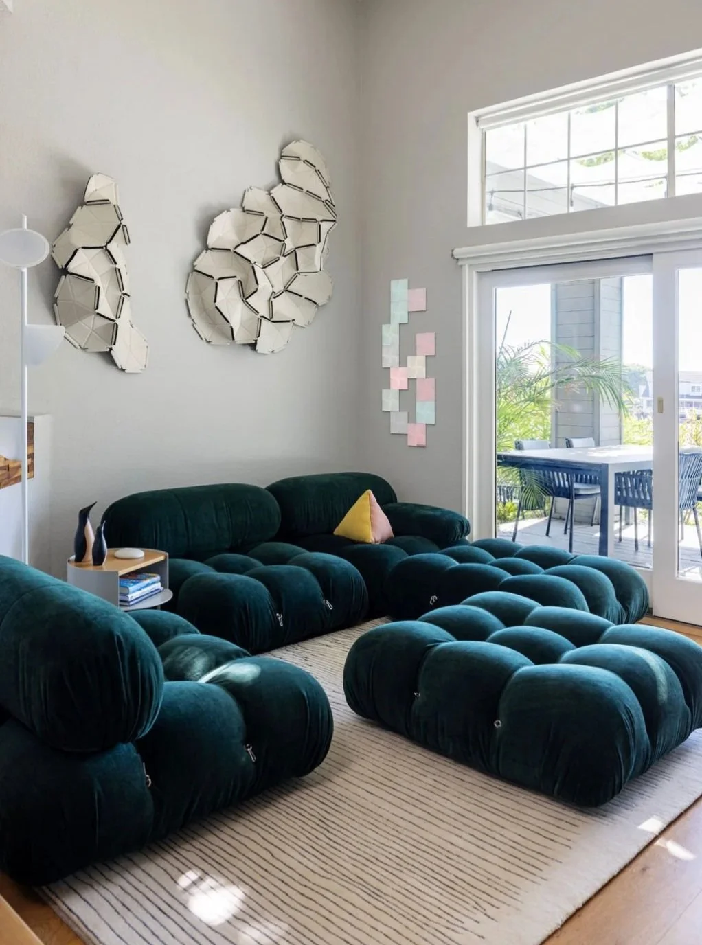 A room doesn&rsquo;t need many pieces to feel complete. 
In this Redwood Shores living room, the deep green modular seating creates a soft, sculptural center within the tall, light-filled space. Its generous proportions make the room feel inviting, w