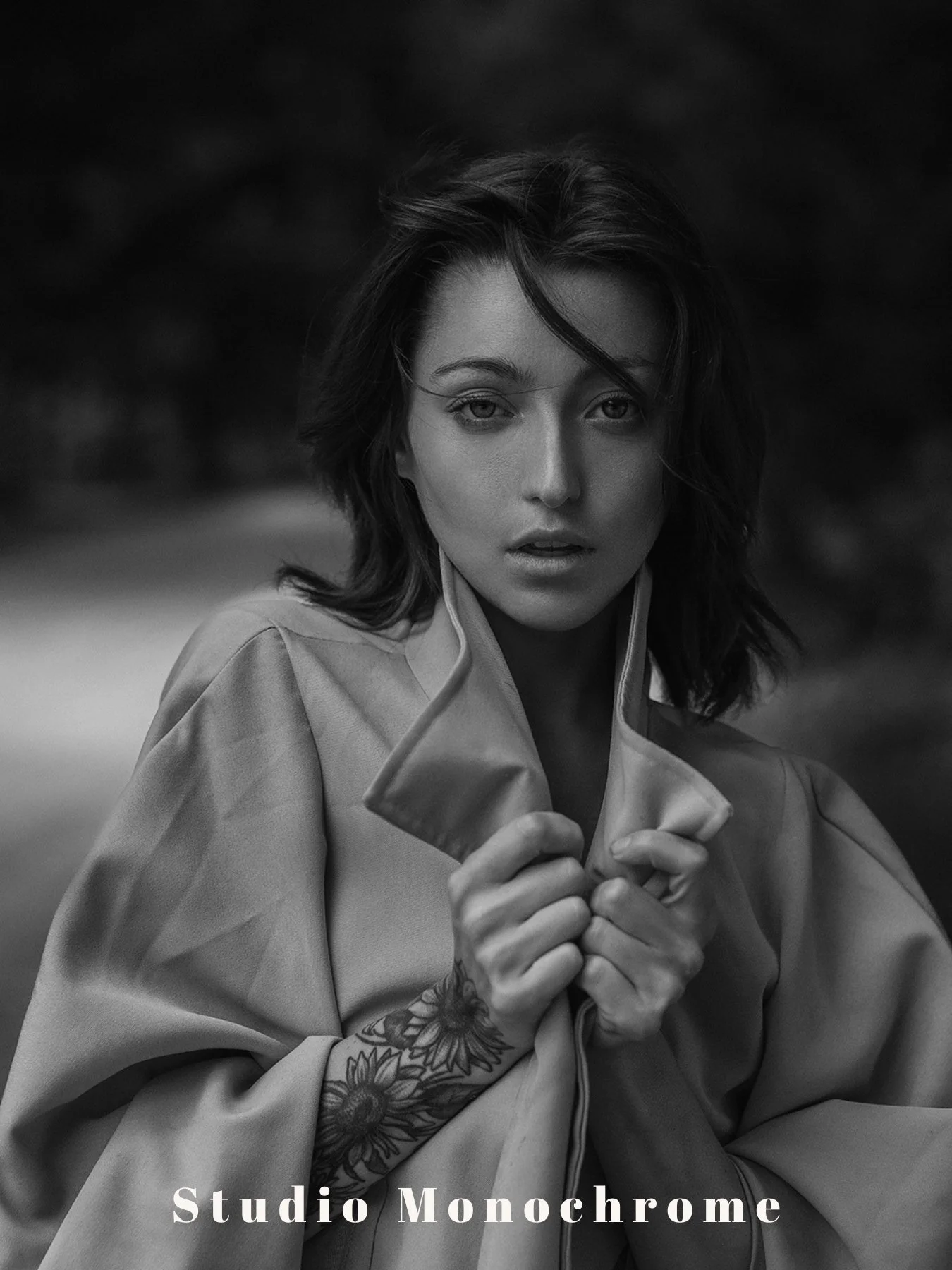 A focused woman's face in stark detail against a soft backdrop, highlighted by the "Studio Monochrome" preset.