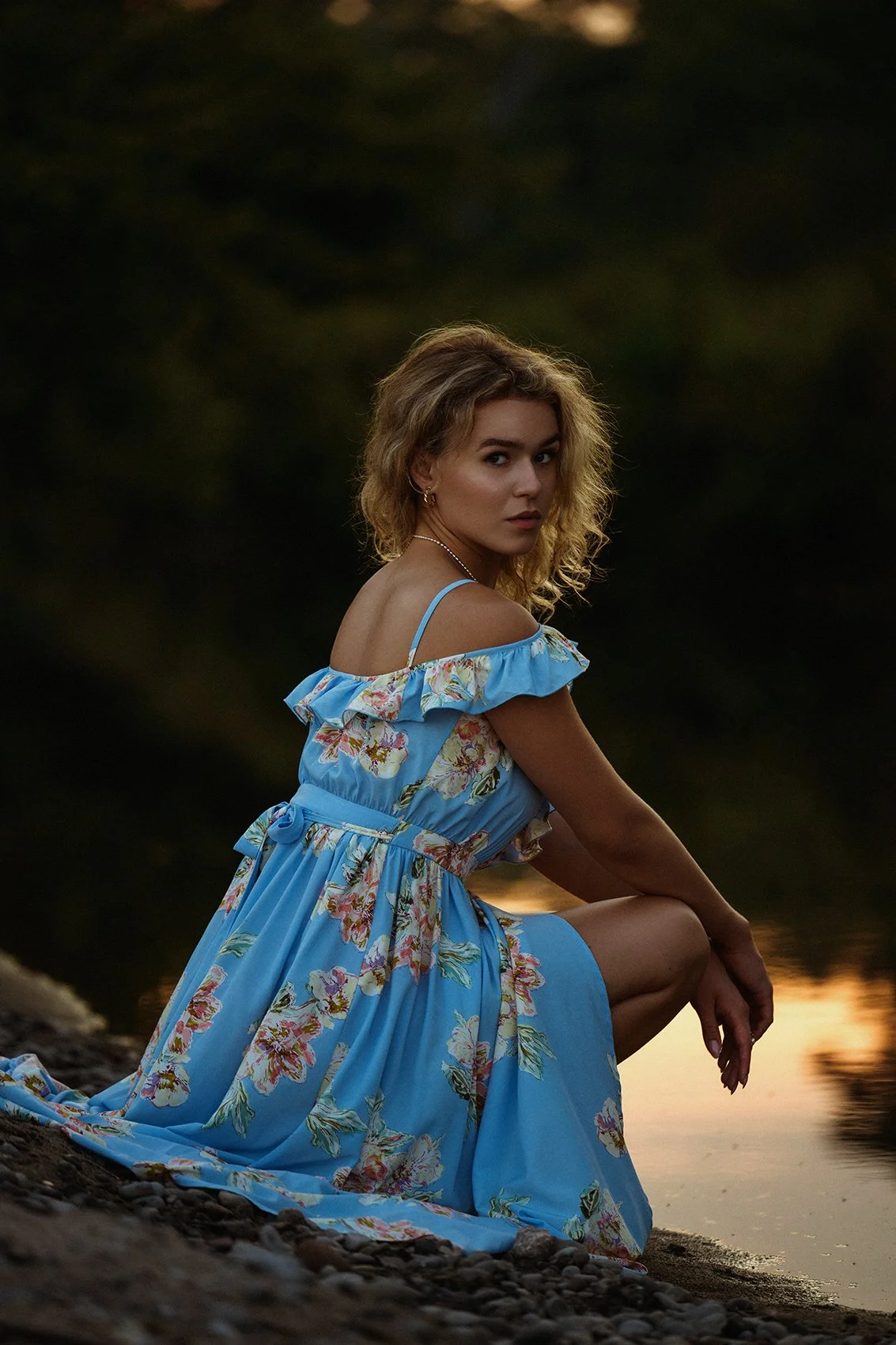 Lifestyle portrait in a blue floral dress by the river