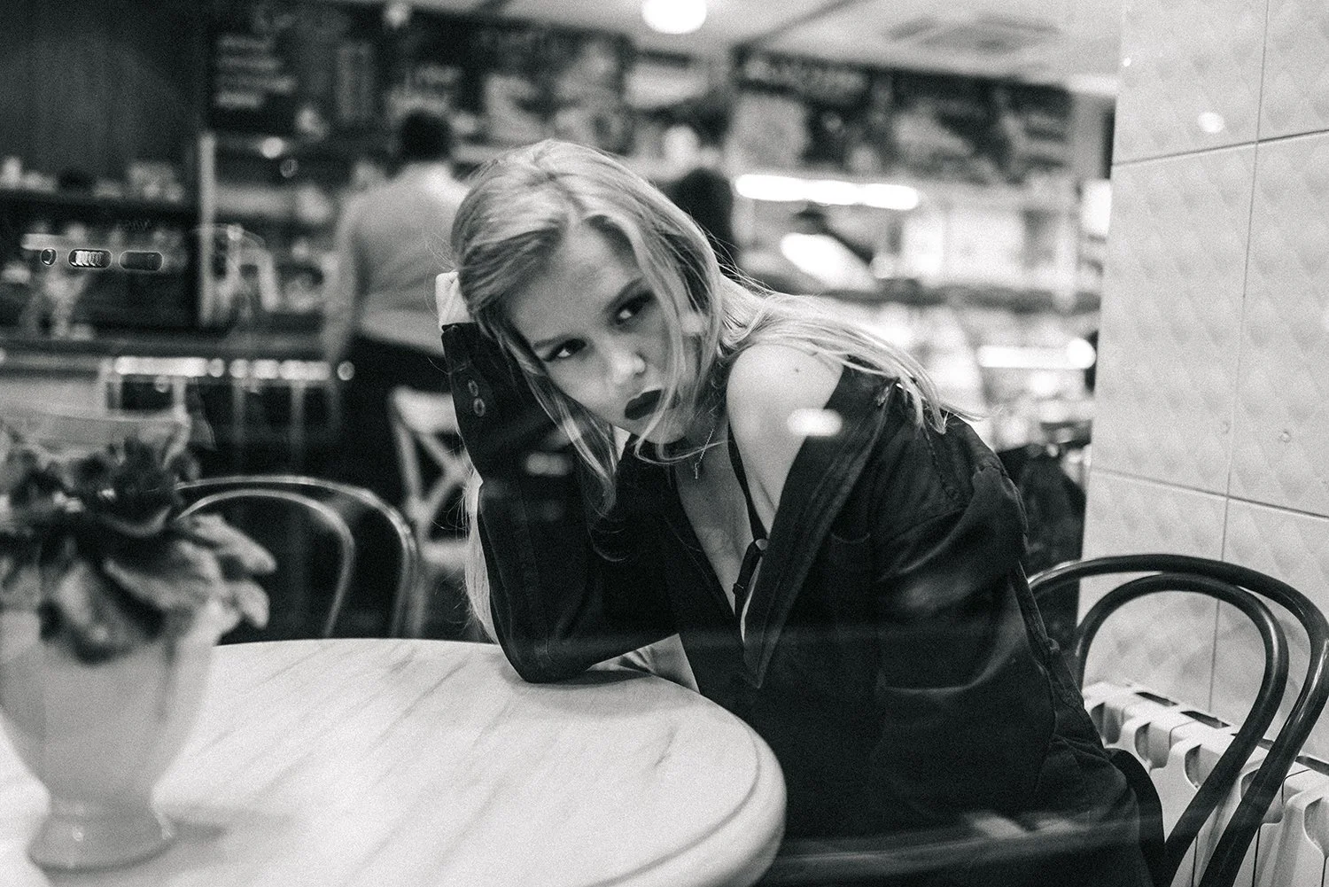 A black-and-white portrait at a café table