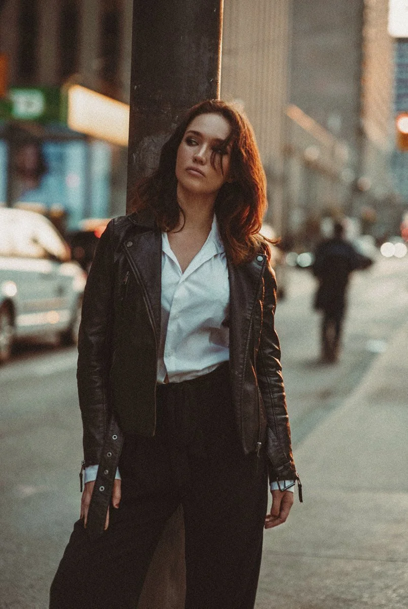 A relaxed city portrait in a white shirt and dark trousers