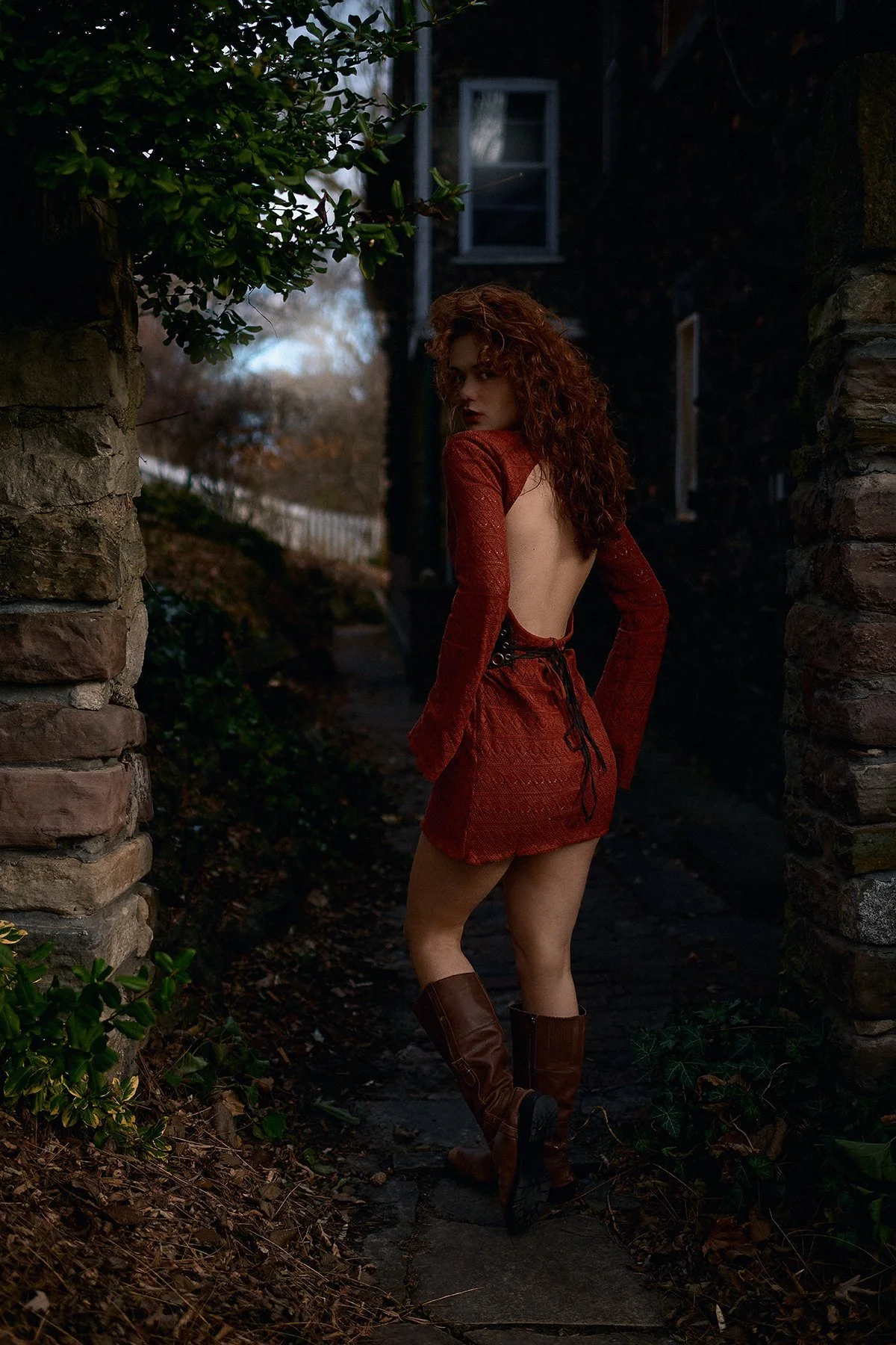 A red dress in a shadowed garden