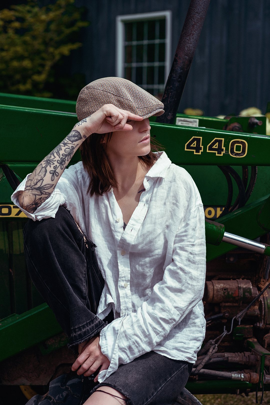 An outdoor portrait beside a green tractor