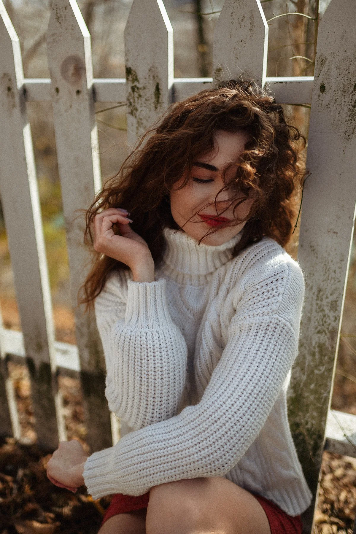 Everyday lifestyle portrait by a white picket fence in Toronto