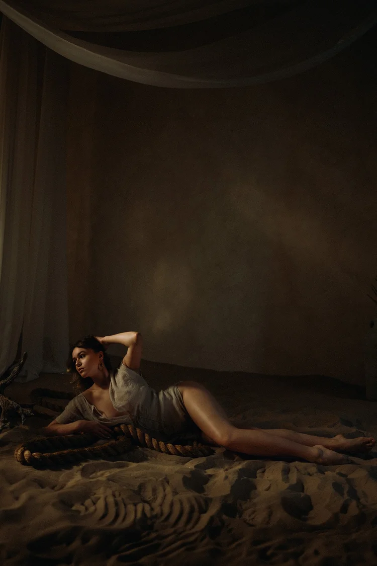 Cinematic boudoir portrait on a textured set