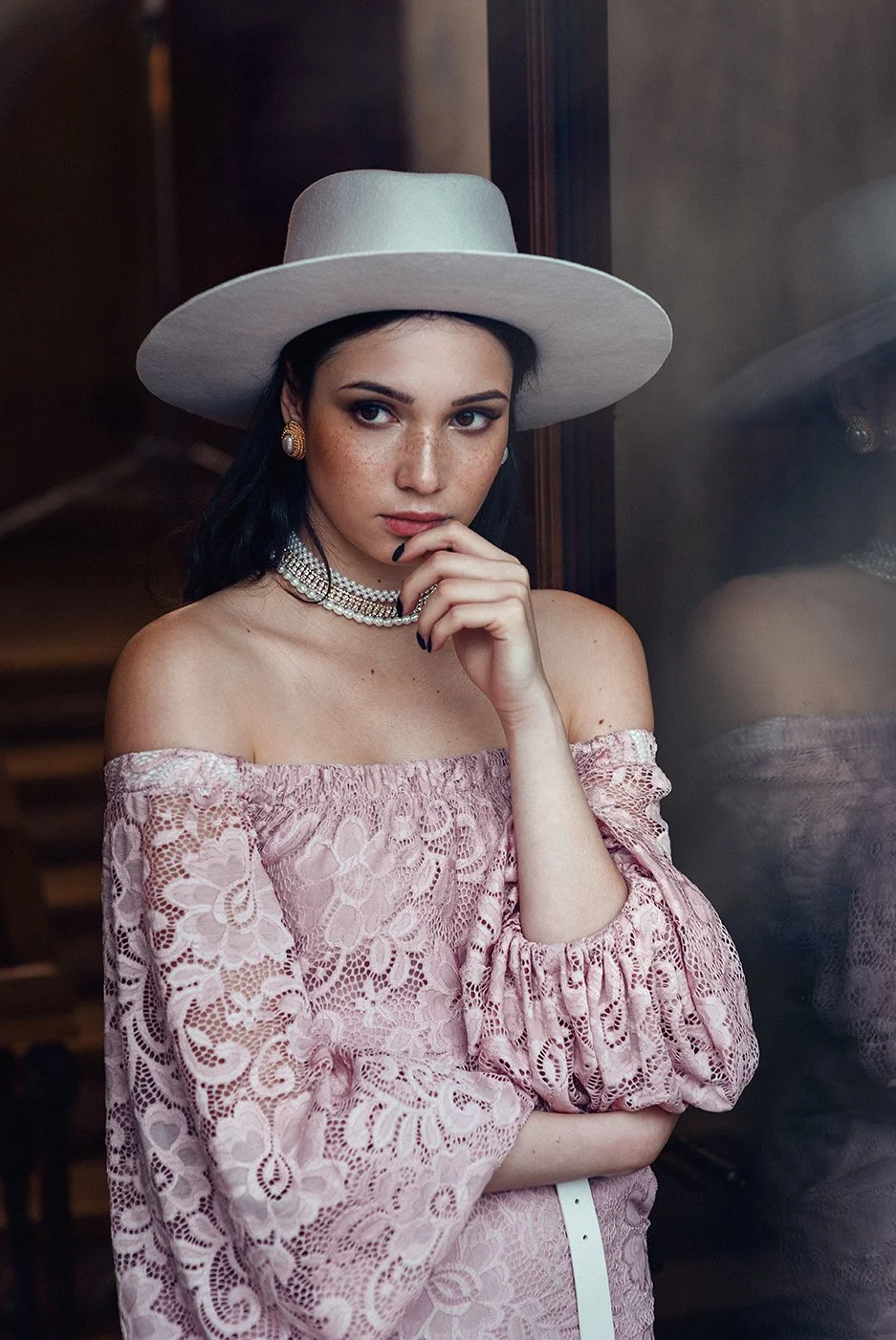 Stylish portrait in a pink dress and white hat
