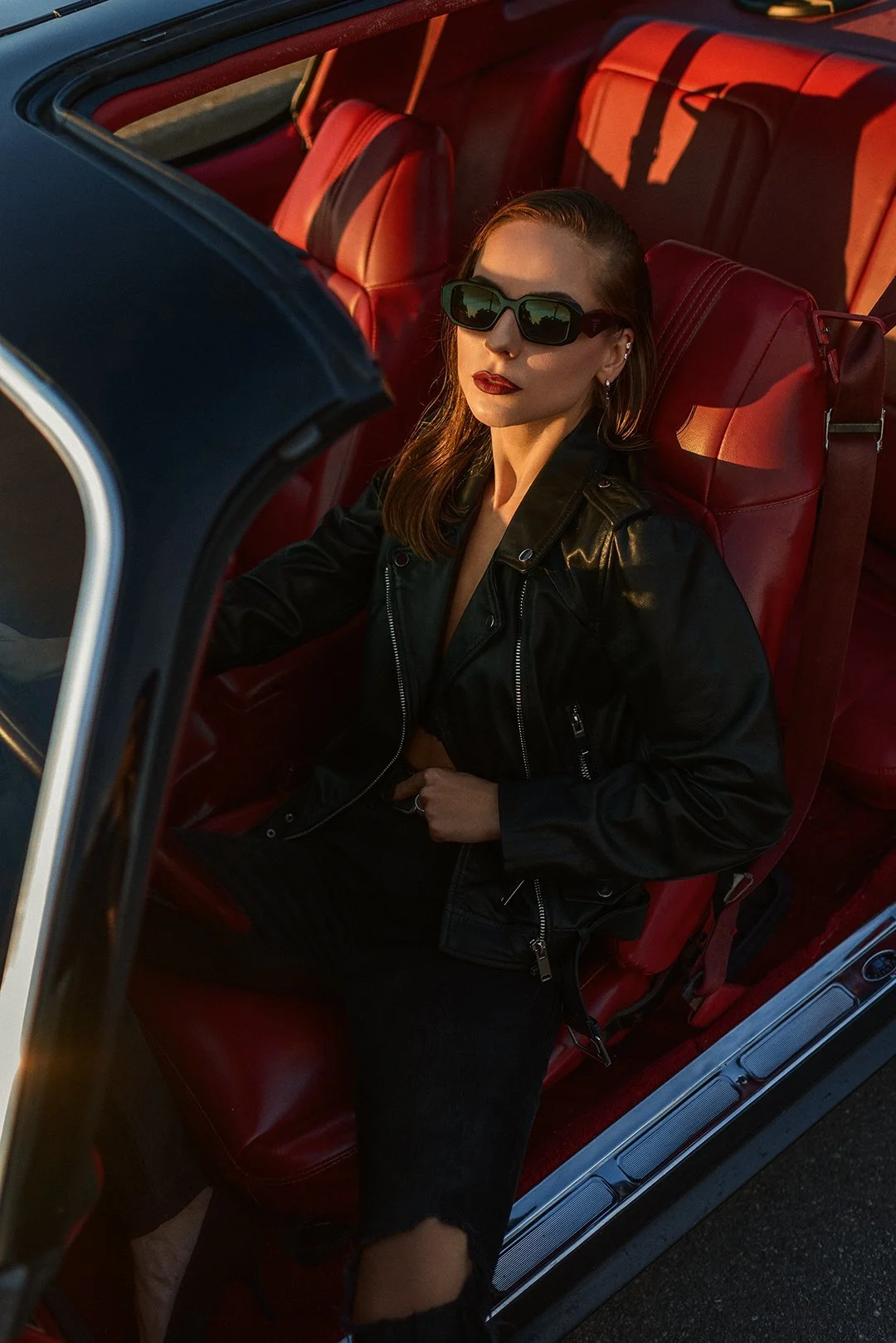 A leather jacket against a red car interior