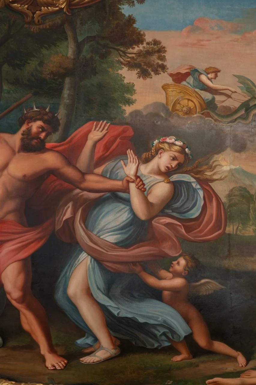 A classical painting depicting a mythological scene with a woman seated on a rock, a man grabbing her arm, and a cherub at her feet. In the background, a chariot with a woman holding a trident and a dragon.