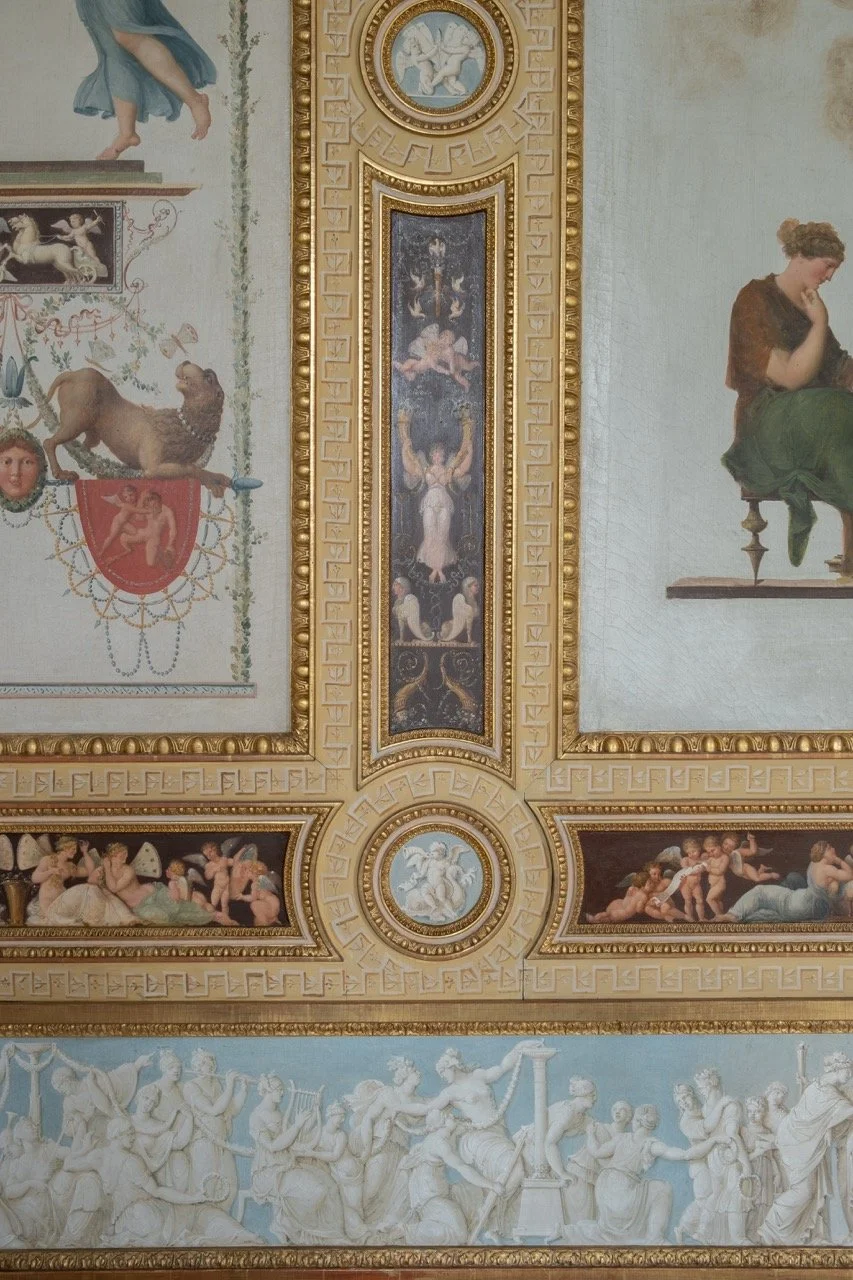 Ceiling with classical-style frescoes and ornate gold trim, featuring mythological and allegorical figures, cherubs, and decorative motifs.