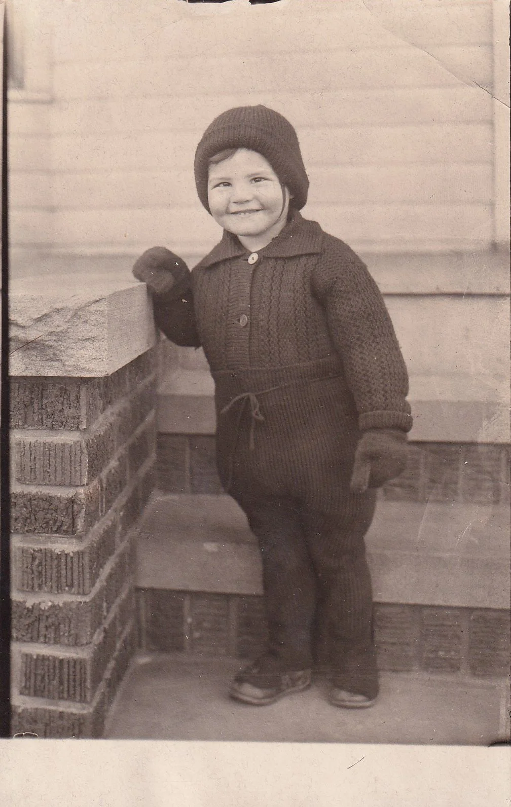 Child in knitted ensemble.