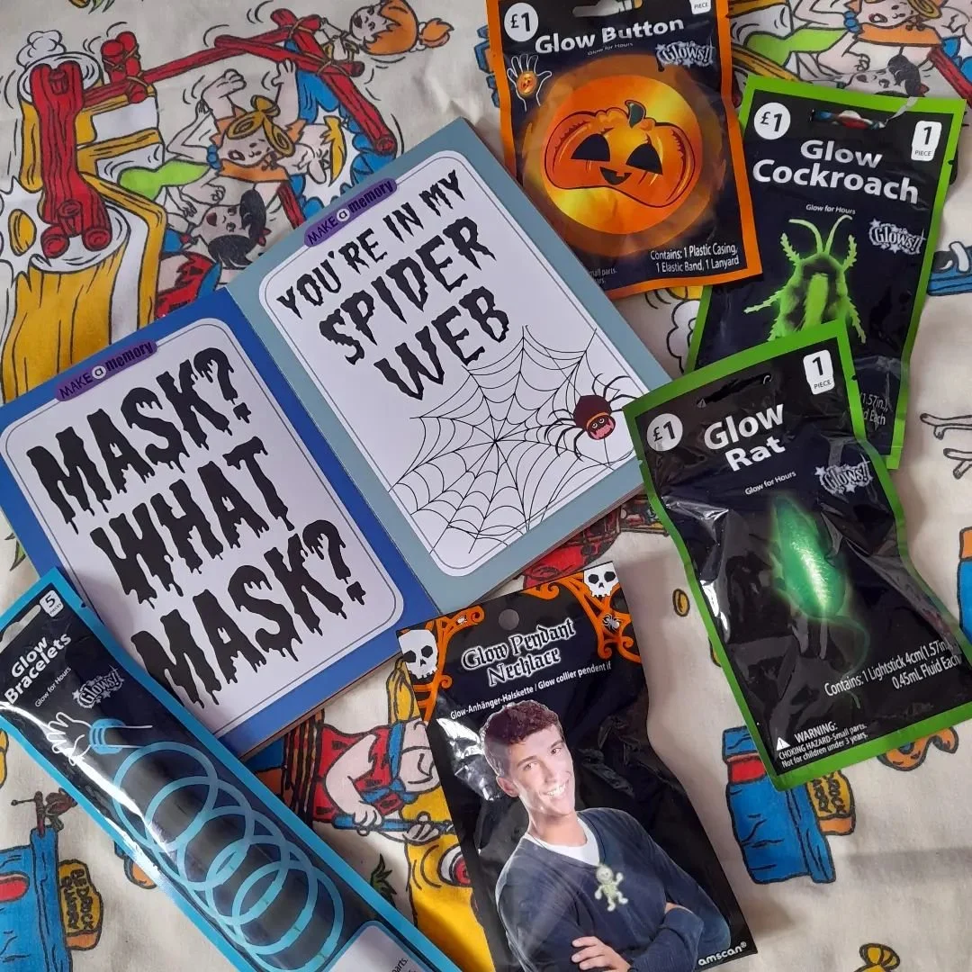 Glow skeleton necklace and a book of Halloween cards, age unknown