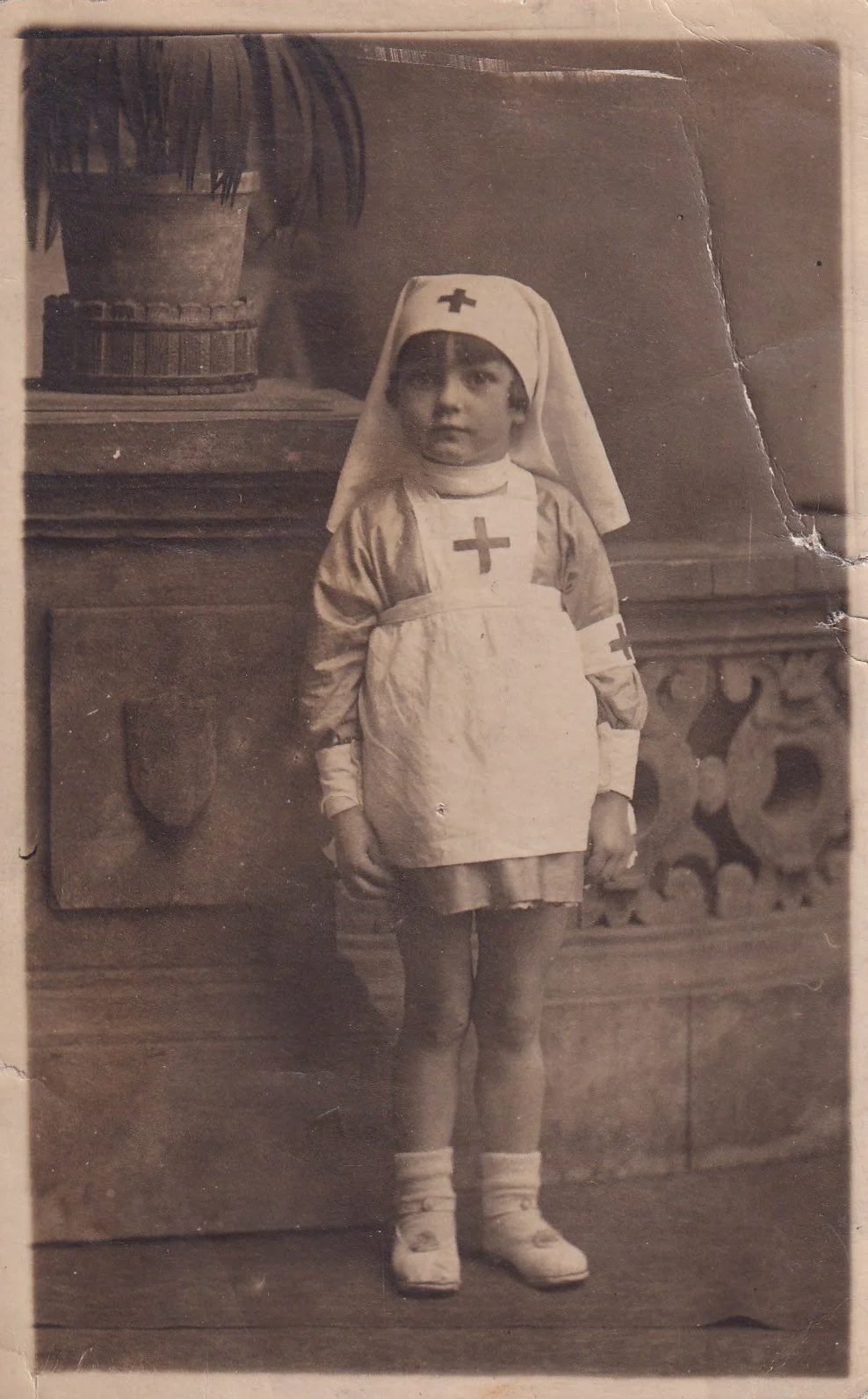 Young girl in nurses uniform, early 20th Century.