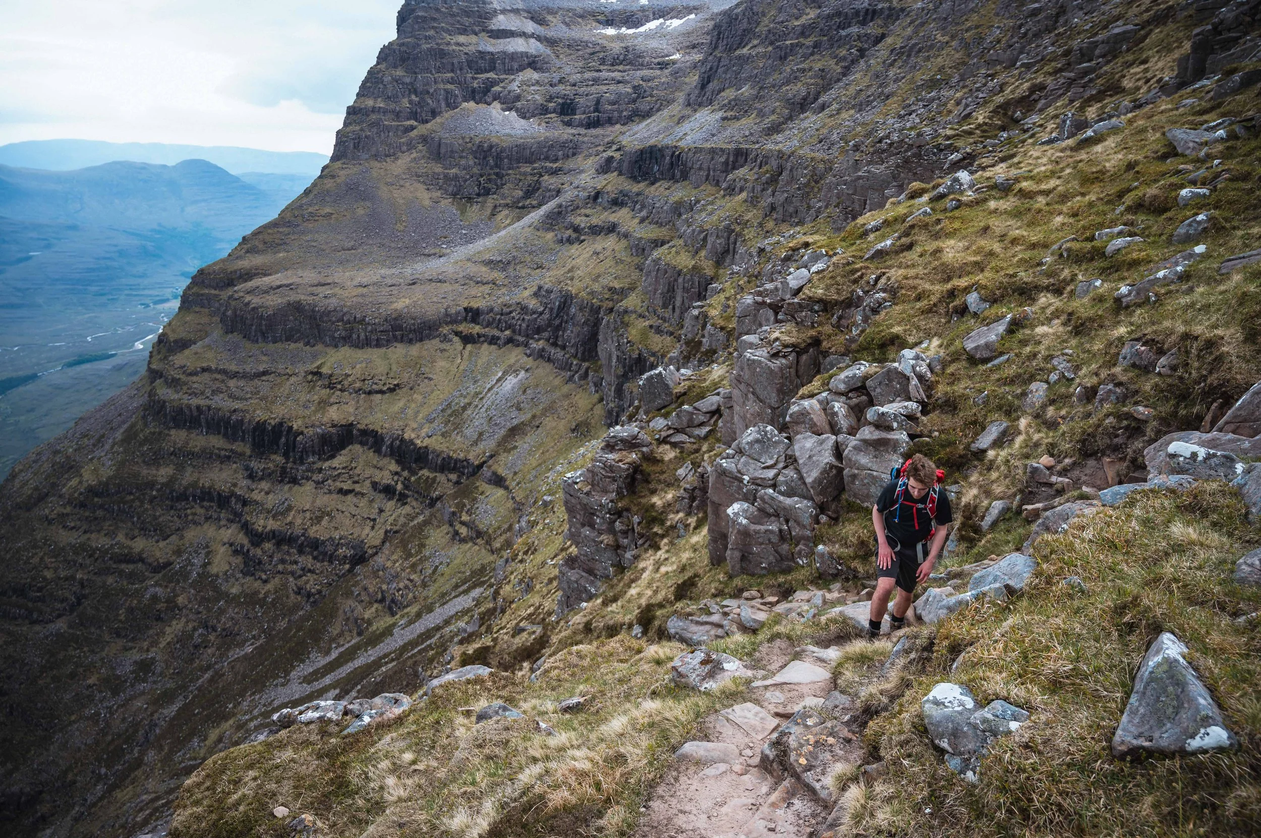 A man climbs the slopes of Liathach