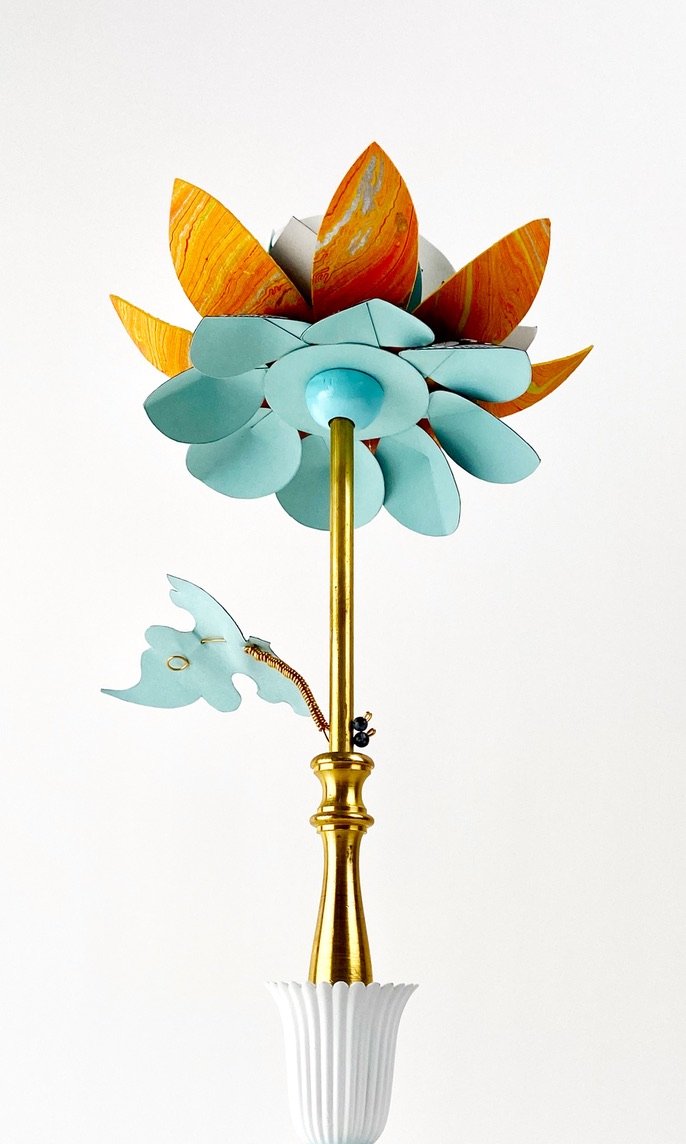 Sunrise Sculpture top from below- a cup and saucer base, lamp parts, brass, paper, beading, and wood make up this table height sculptre that resembles a flower