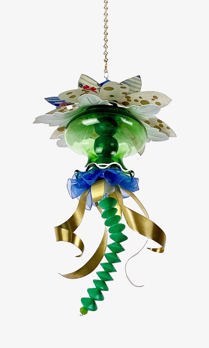 This is a view from below. You can see the change in paper on the underneath side and the wood balls inside the glass vase. The piece is made out of lamp parts, paper sheet metal ribbon and beads. It hangs from a chain that you can cut to the length