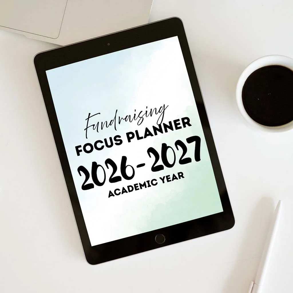 Fundraising Focus Digital Planner showing on a tablet, sitting on a table with a cup of coffee.