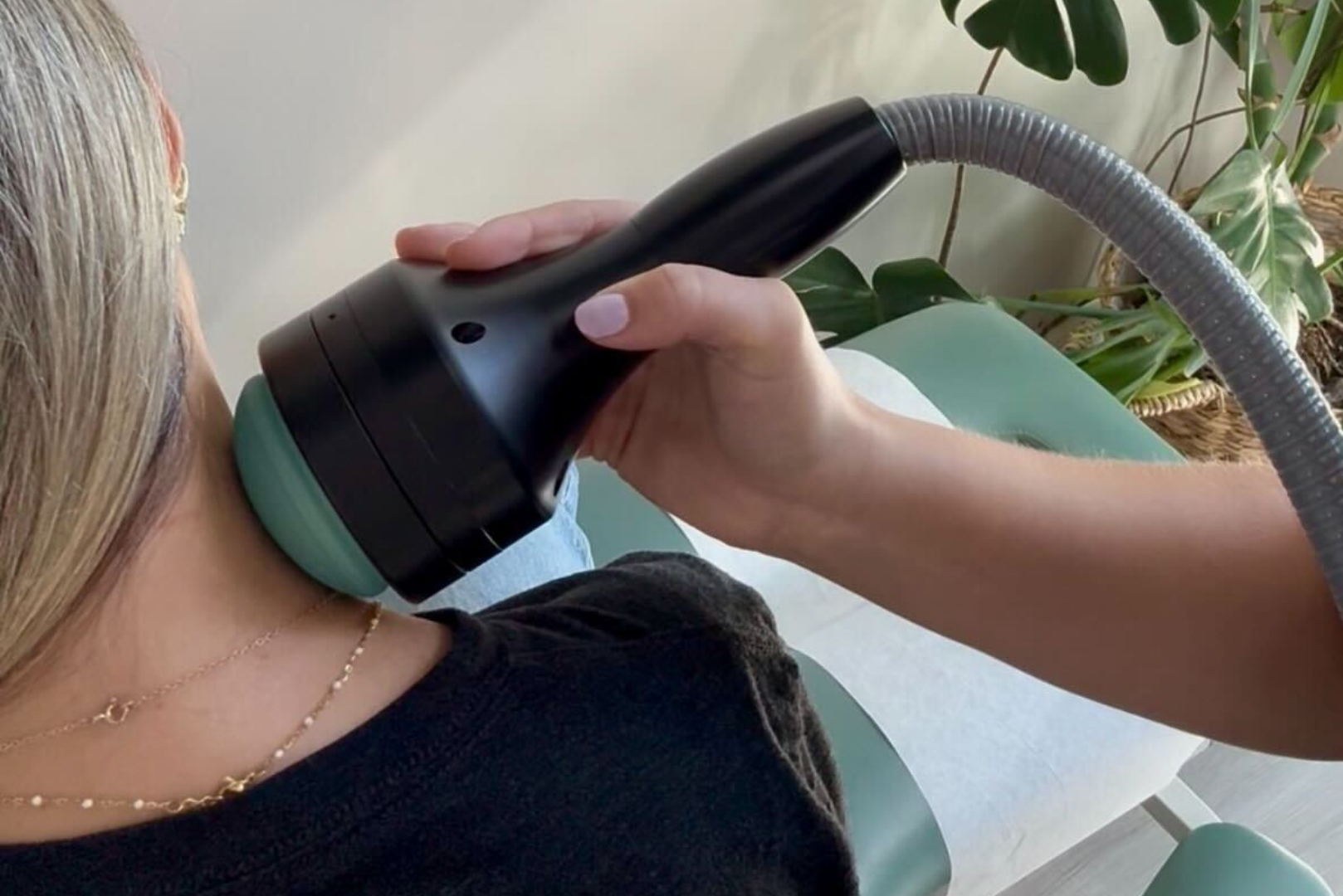 Shockwave therapy applicator treating patient’s neck for muscle tension and pain at The Wellness Way Sarasota