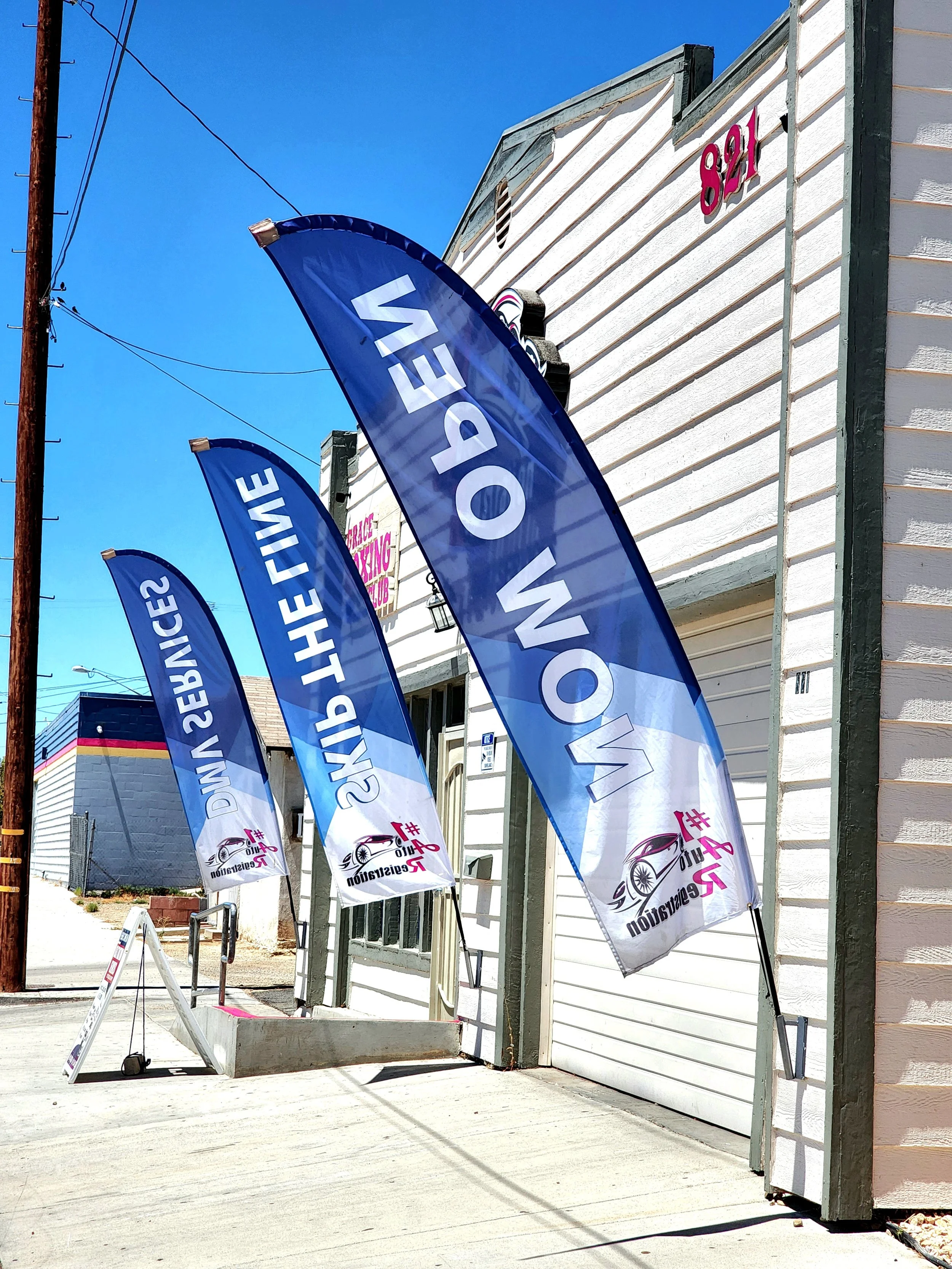 Banners advertising a sale at a dealership, with the words 'WE FINANCE' and a logo for Car Restoration and Customization.
