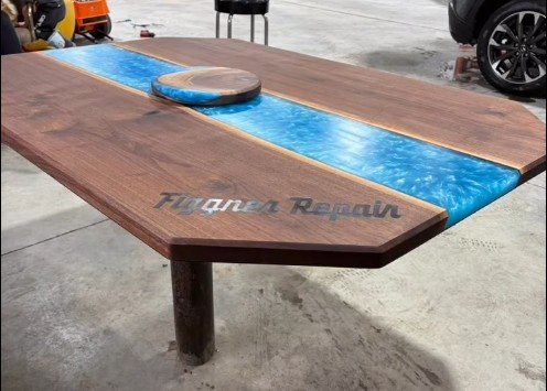 Walnut river table, customer made. Kneifl Tymber assisted with CNC routing the logo