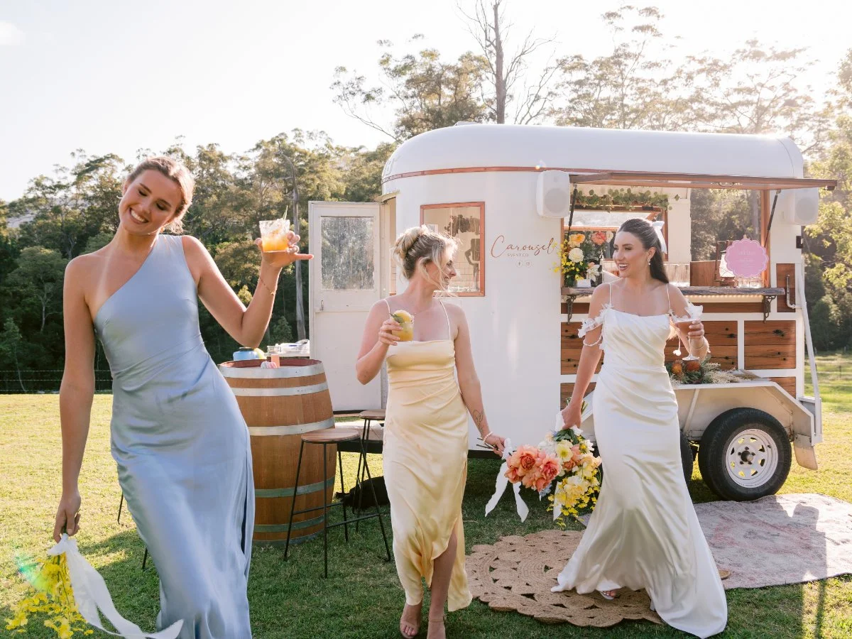 Bridal party beside a rustic horse float wedding bar