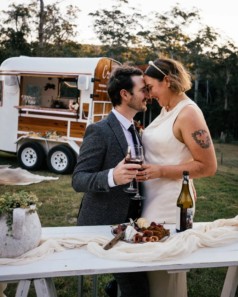 Wedding couple celebrating beside a vintage horse float bar