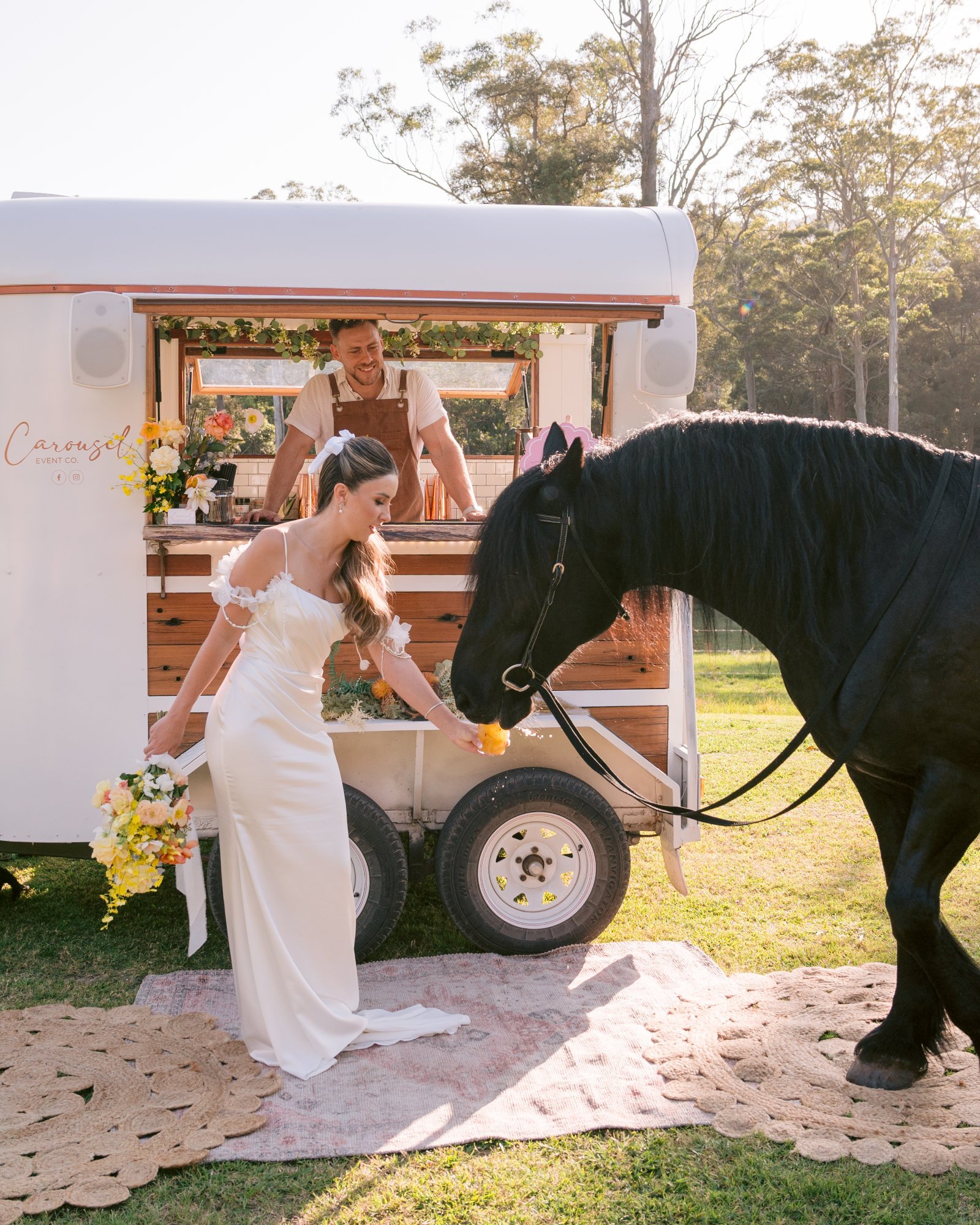 Bride with horse beside Carousel's mobile wedding bar at Cedar Banks