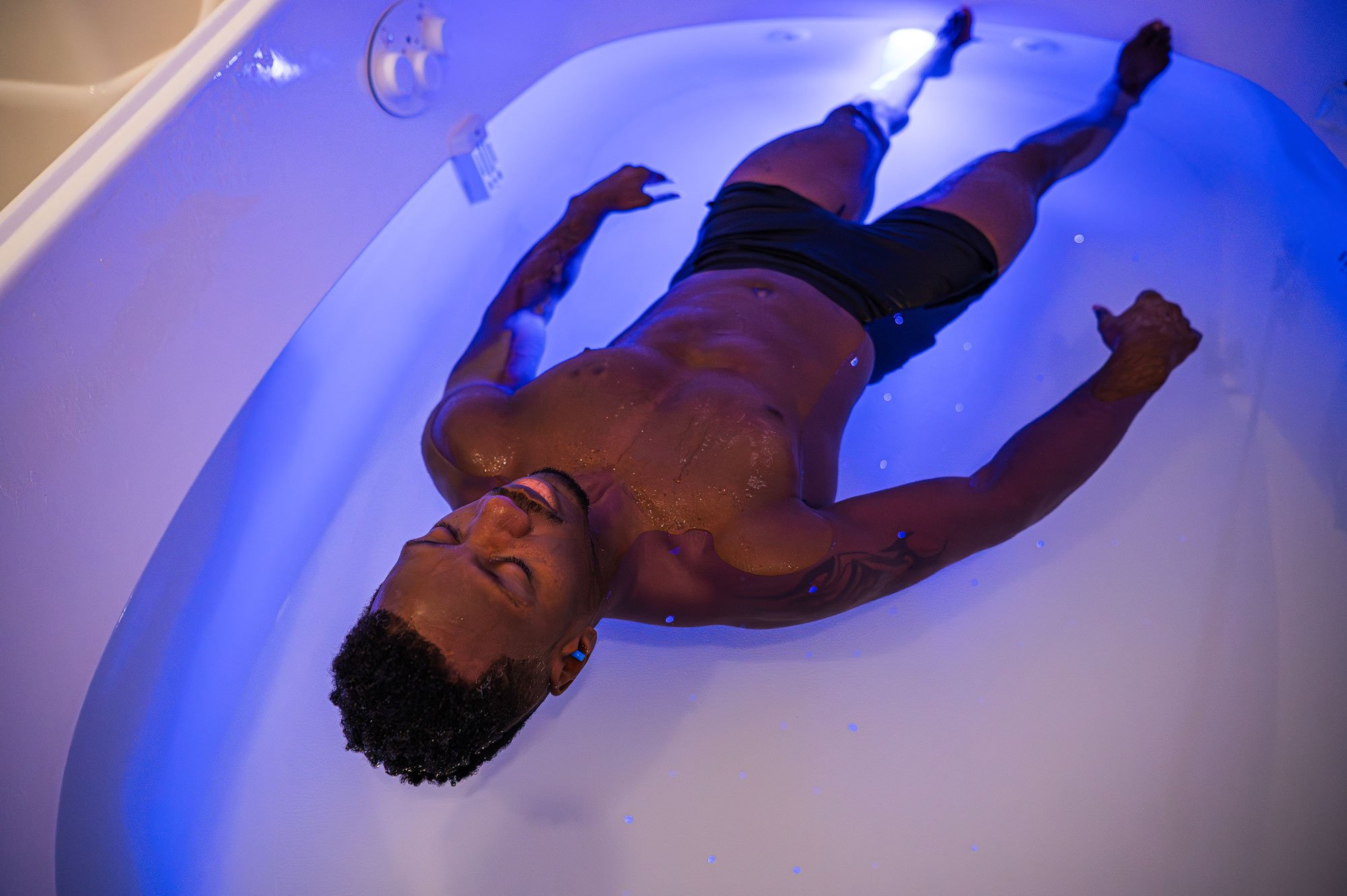 Employee floating during a corporate wellness Float Therapy session at The Salt Center in Alpharetta, GA