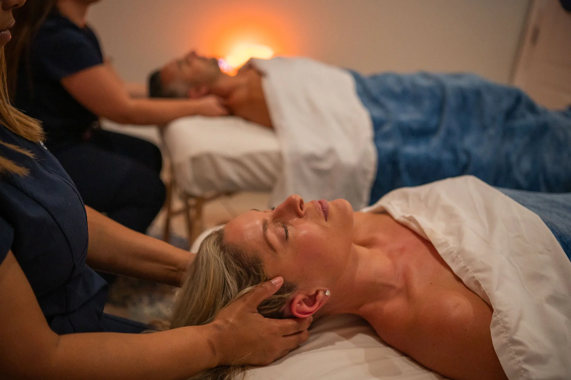 Guests receiving customized therapeutic massage with heated stone therapy at The Salt Center in Alpharetta, GA